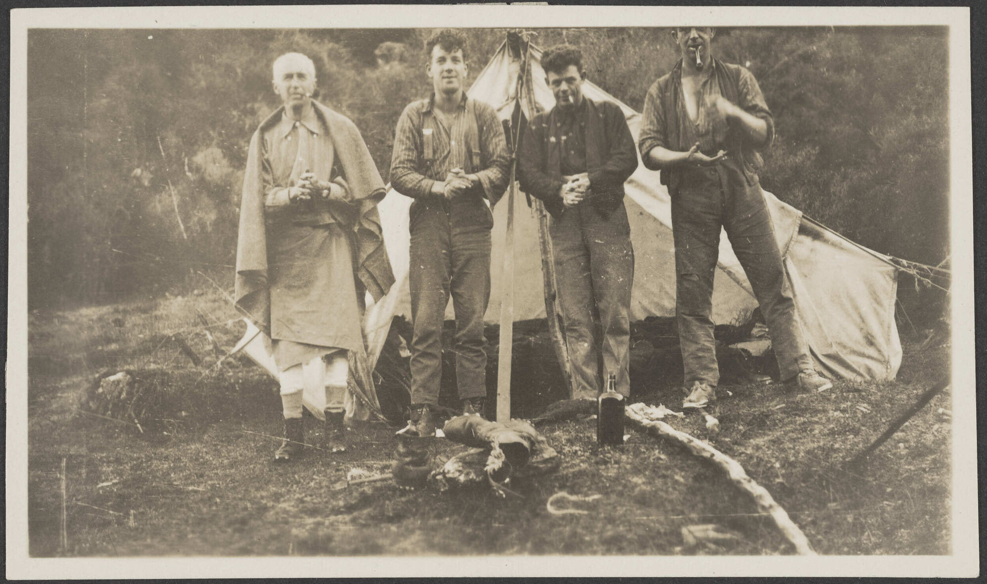 Four men outside tent