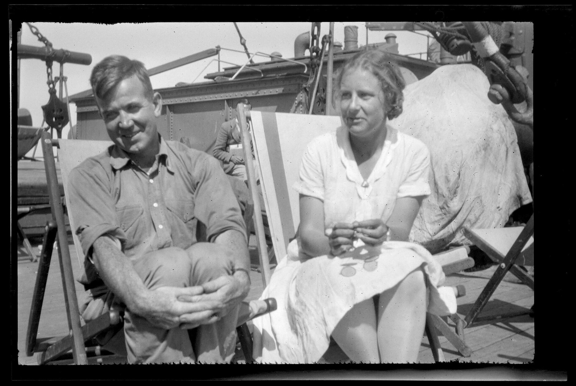 Man and woman sitting on deck chairs on the Barrabool