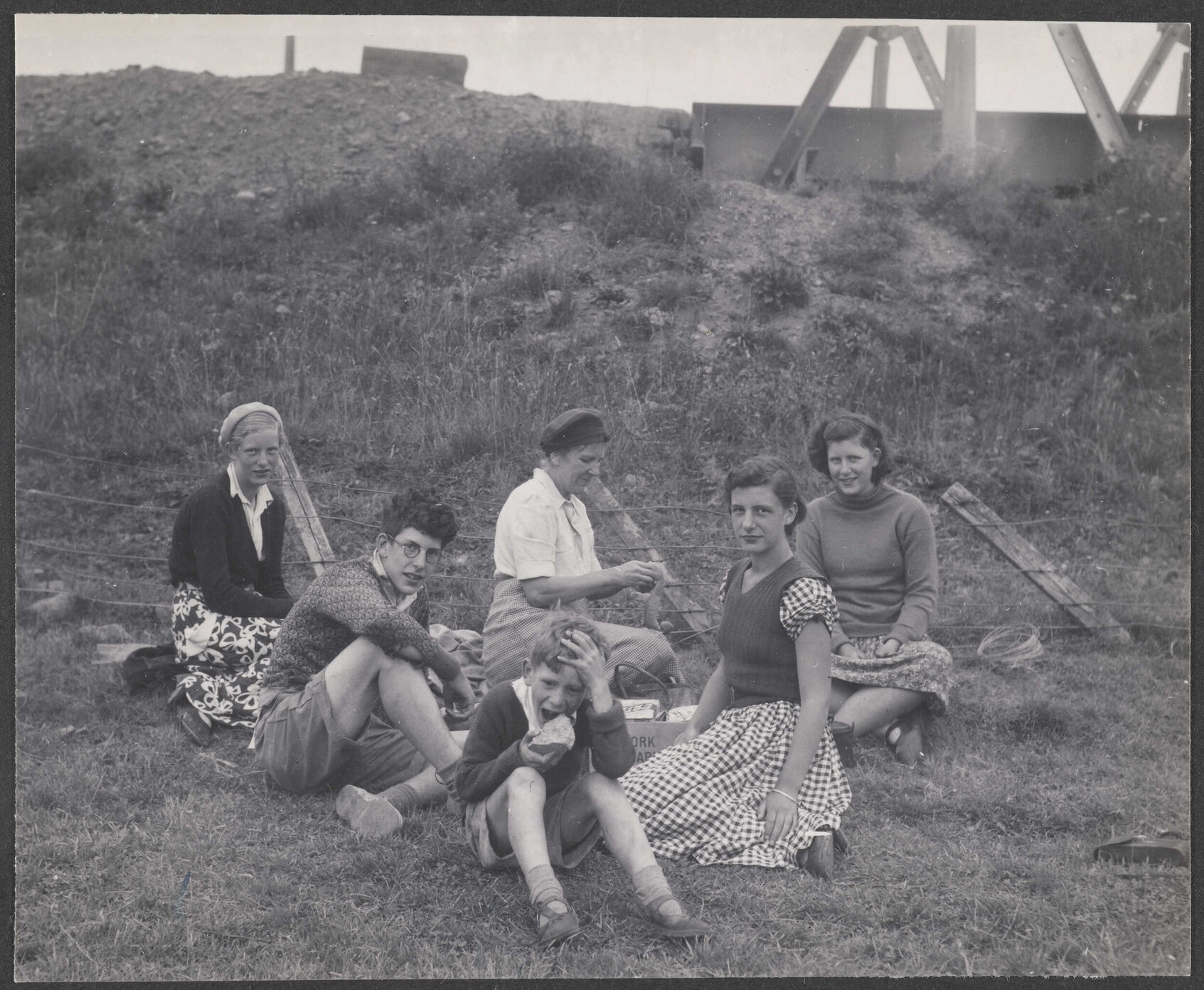 Hamilton family having picnic by bridge