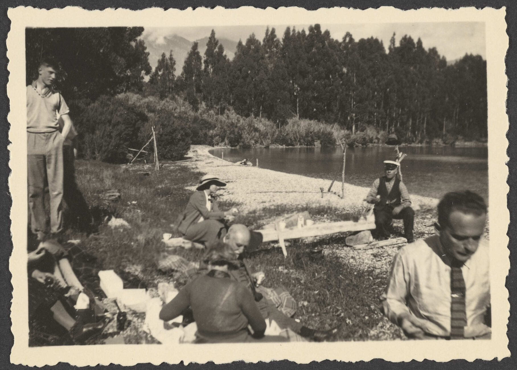 Group of people eating by lake