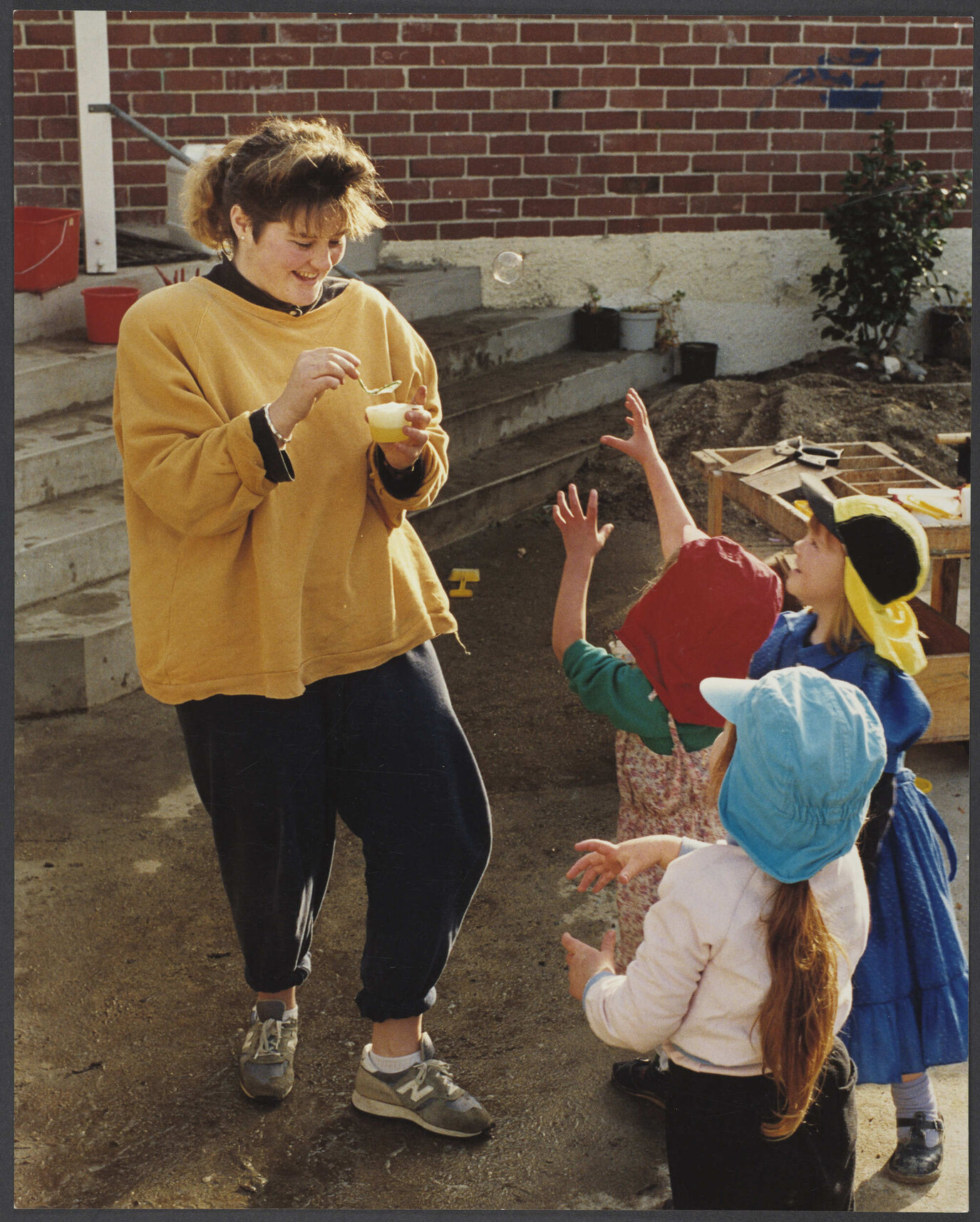 Teacher and children with bubbles