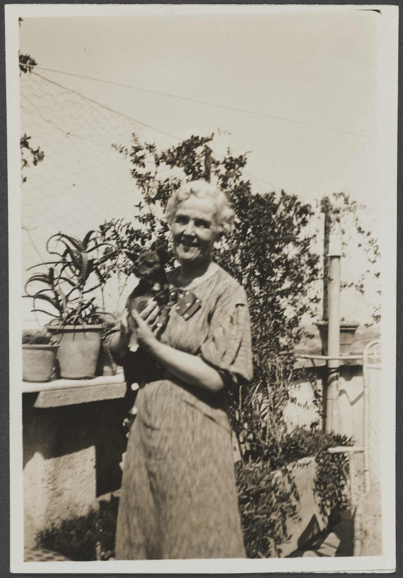 Unidentified woman holding a dog