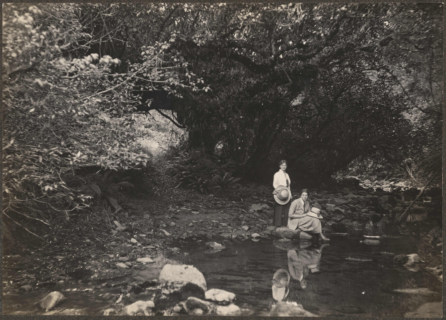 Two unidentified women by a river