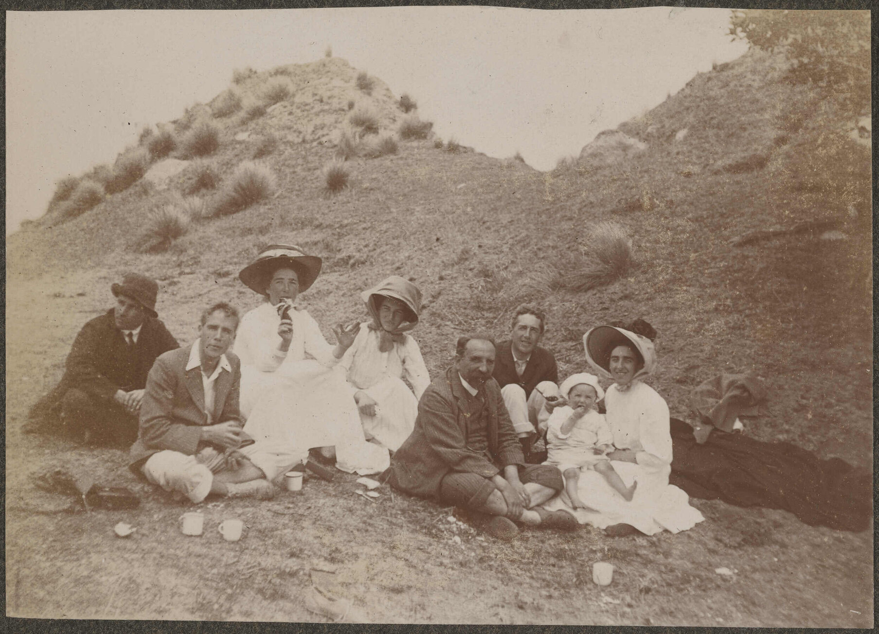 Family picnic on a bank with tussocks