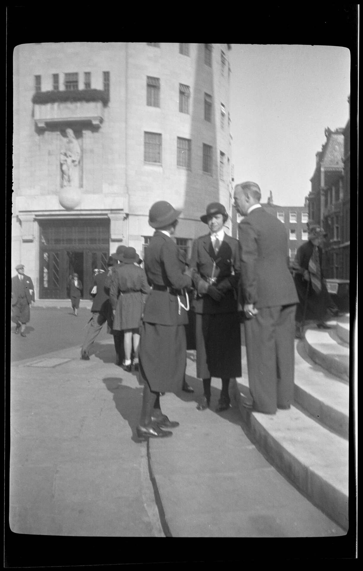 People including Girl Guides beside the steps of All Souls' Church, Langham Place, London