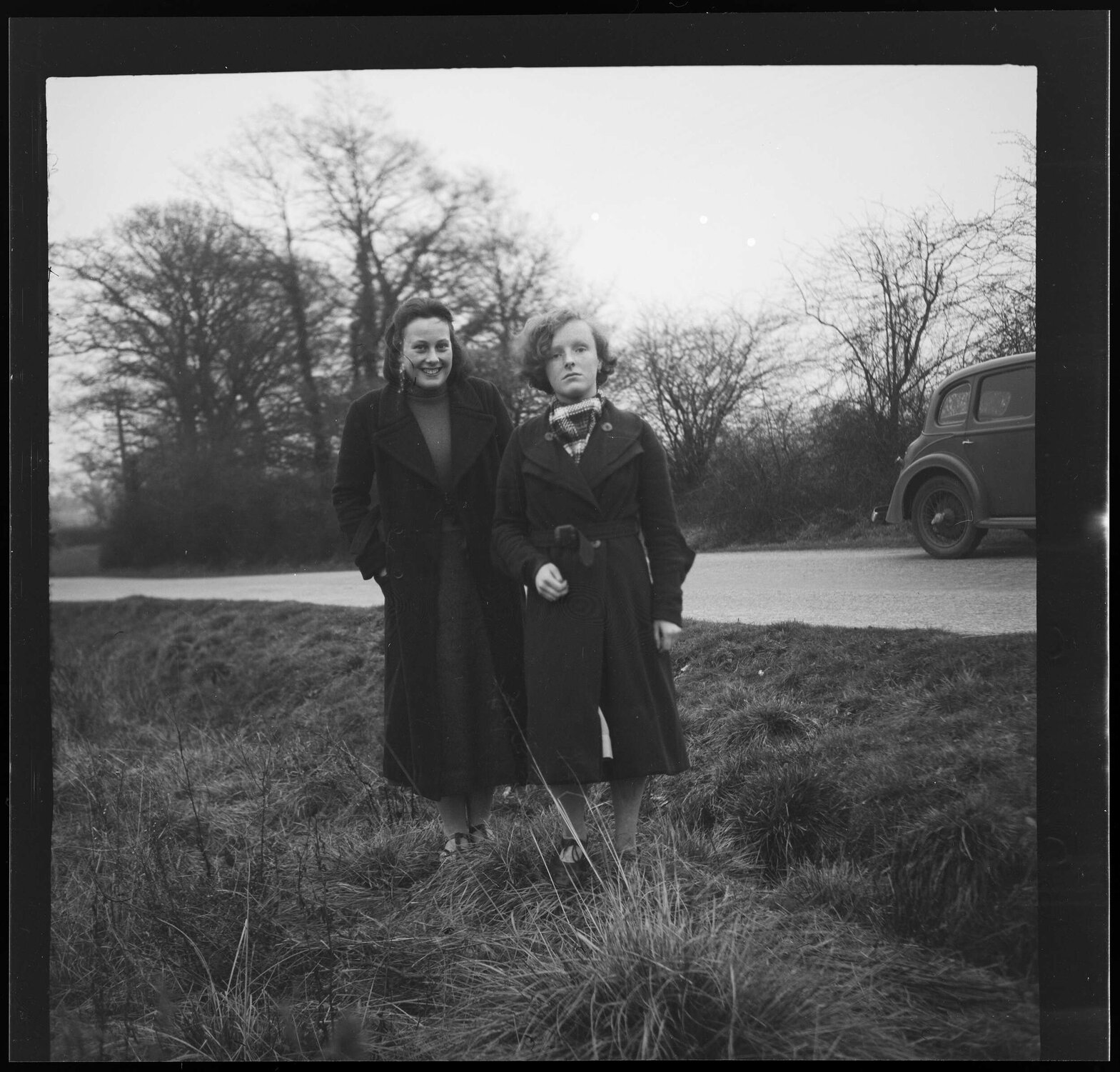 Two girls wearing coats [Connie and Edna]