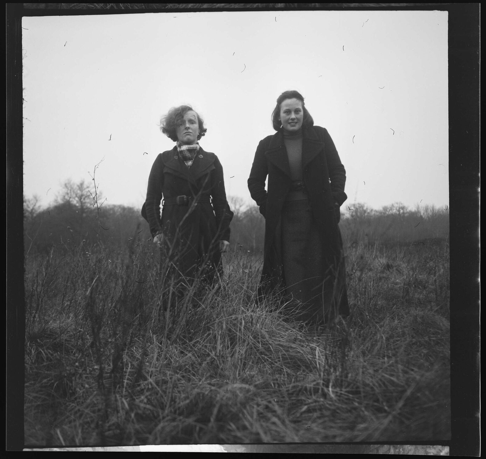Two girls wearing coats [Edna and Connie]