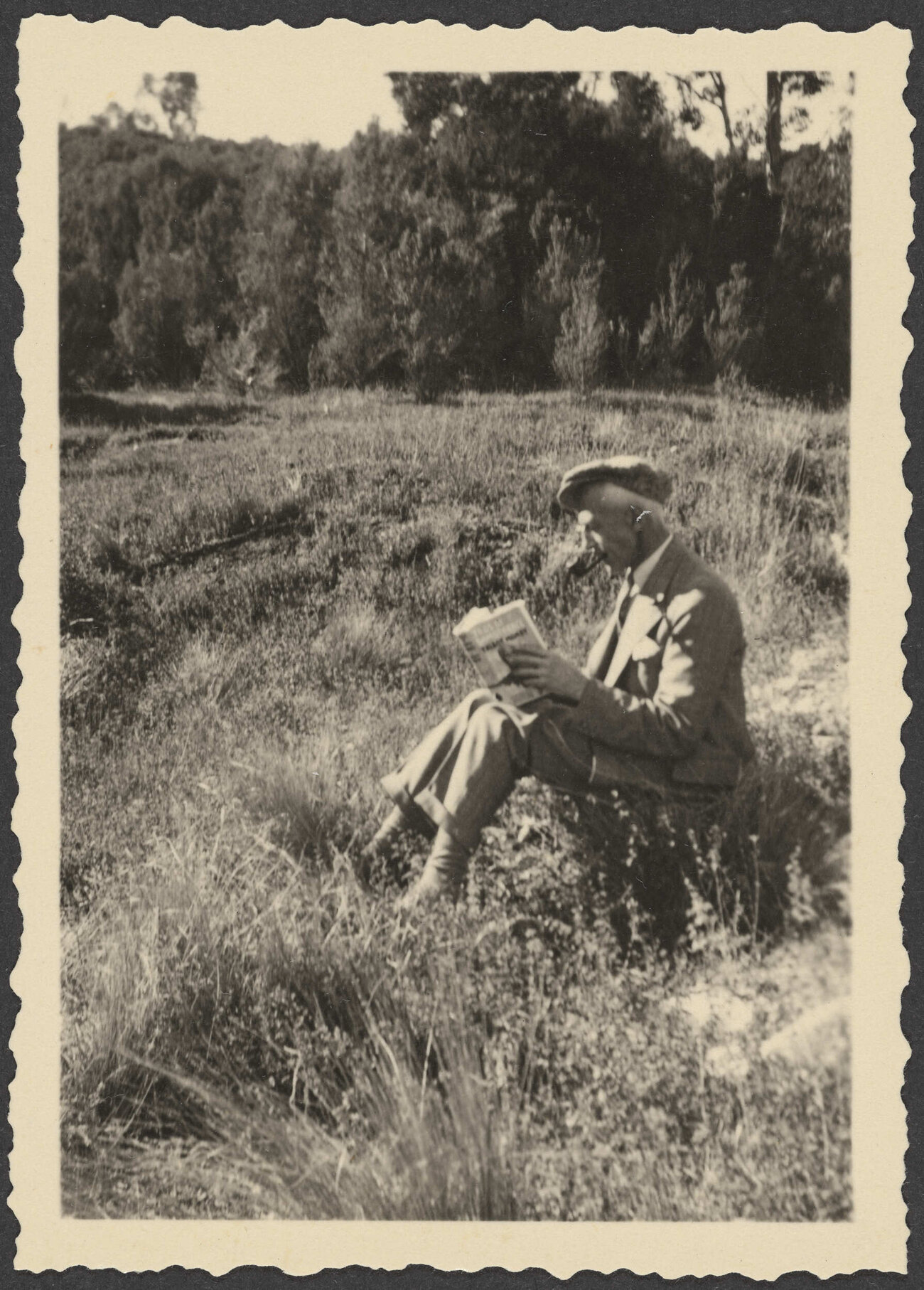 [Henry Brasch] reading a book outdoors