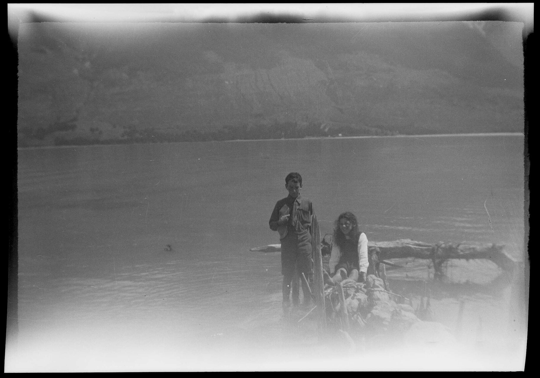 Boy and girl beside a body of water