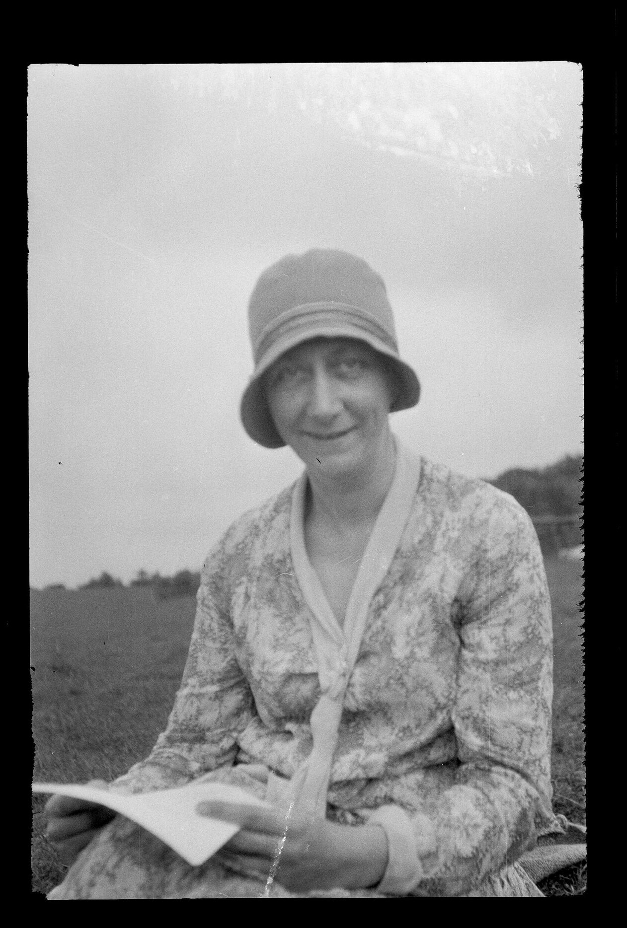 Unidentified woman sitting on grass