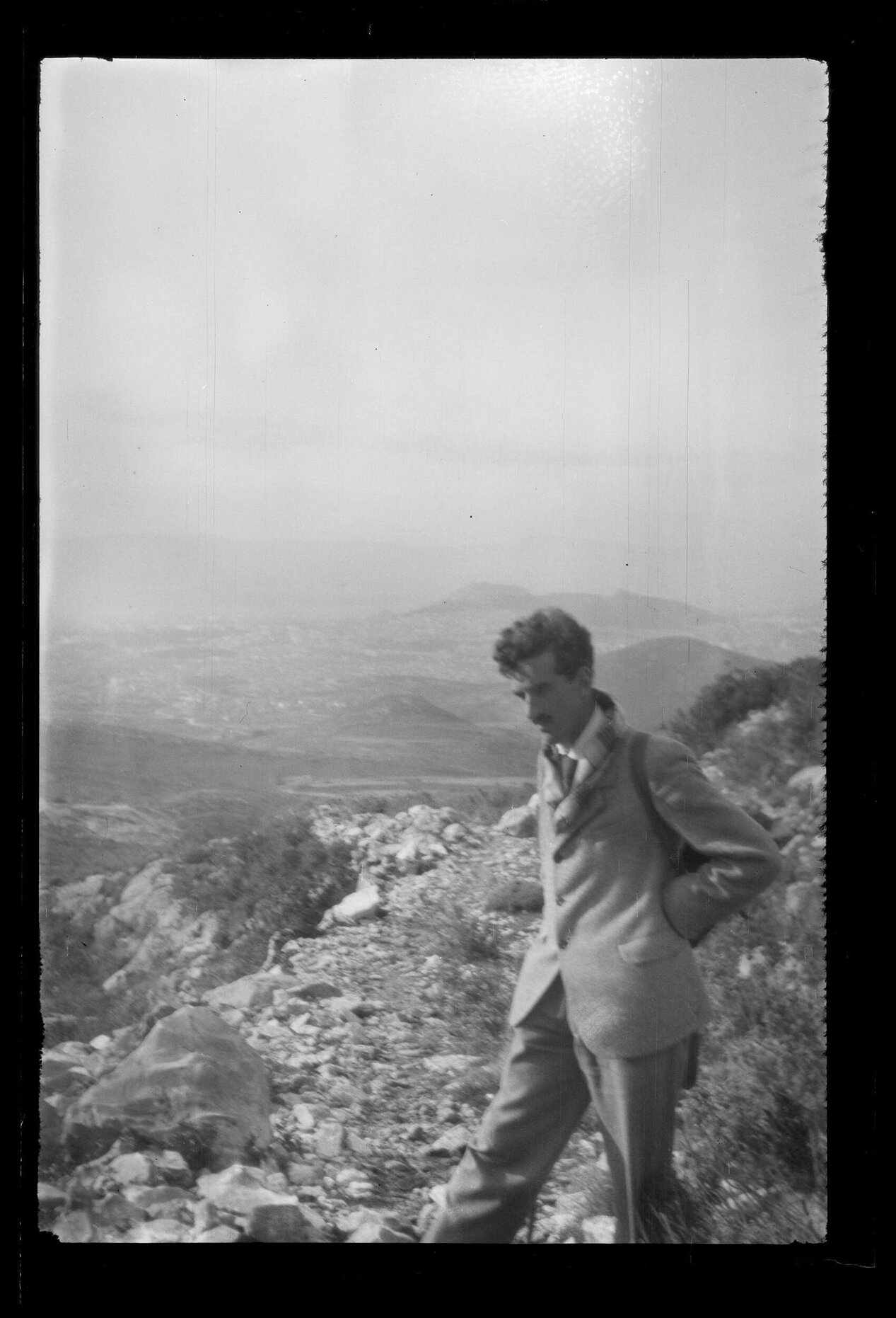 Charles Brasch with elevated view in background