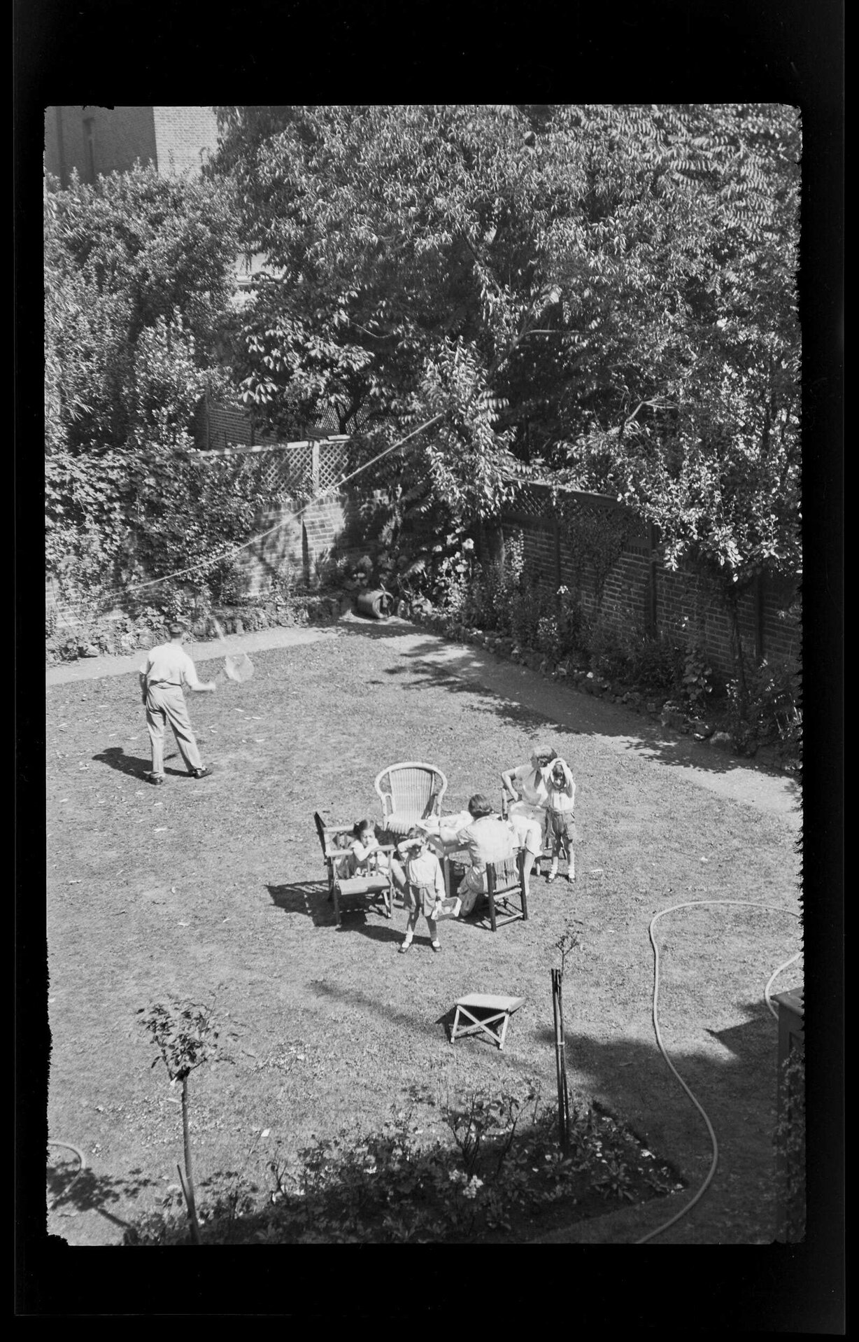 Children and adults in a domestic garden, viewed from above