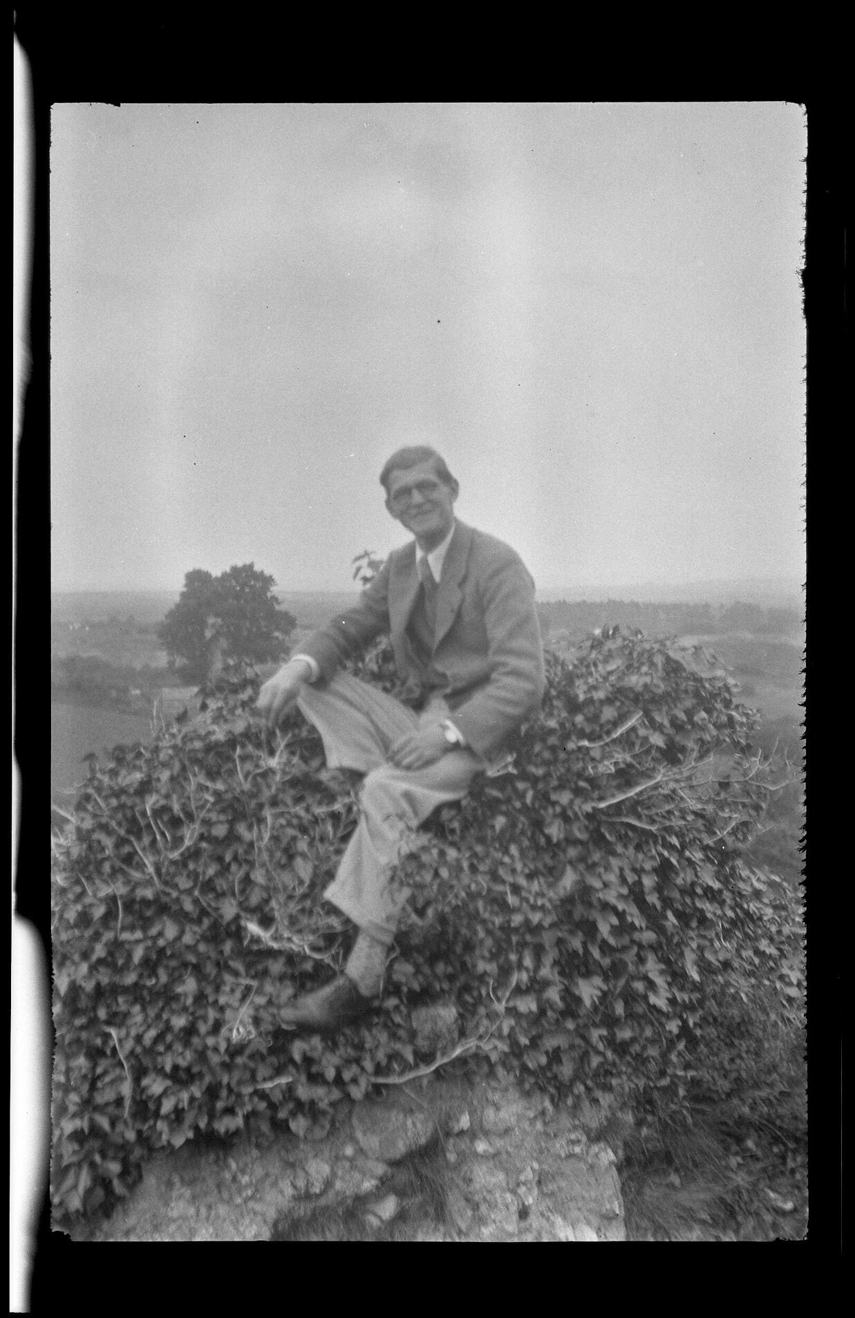 Unidentified man sitting on ivy