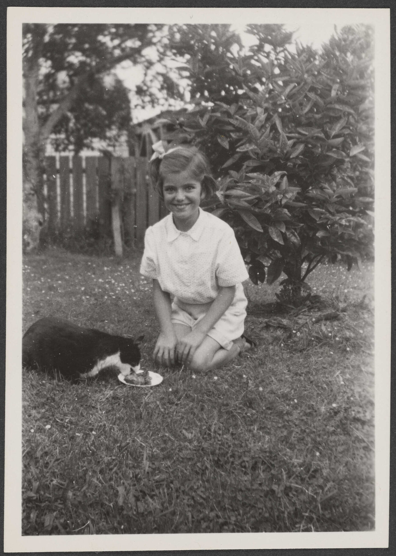 Jannabelle Archdall with a cat in a garden