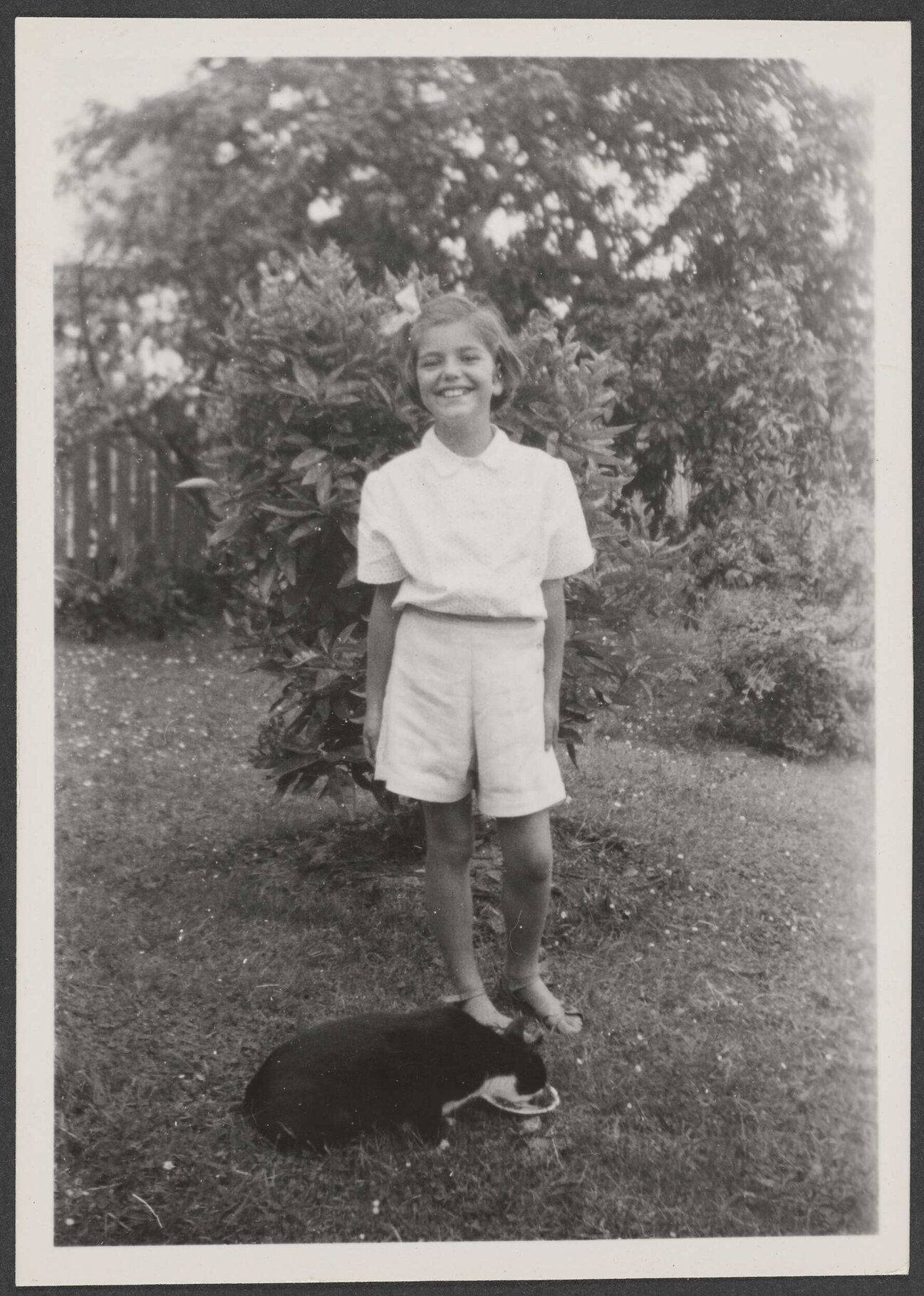 Jannabelle Archdall with a cat in a garden
