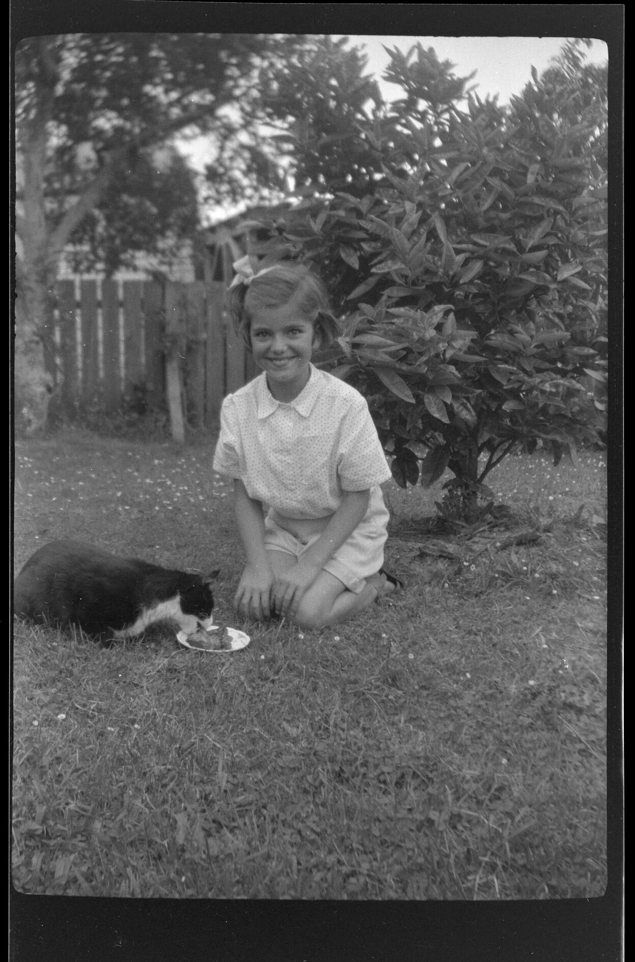 Jannabelle Archdall with a cat in a garden