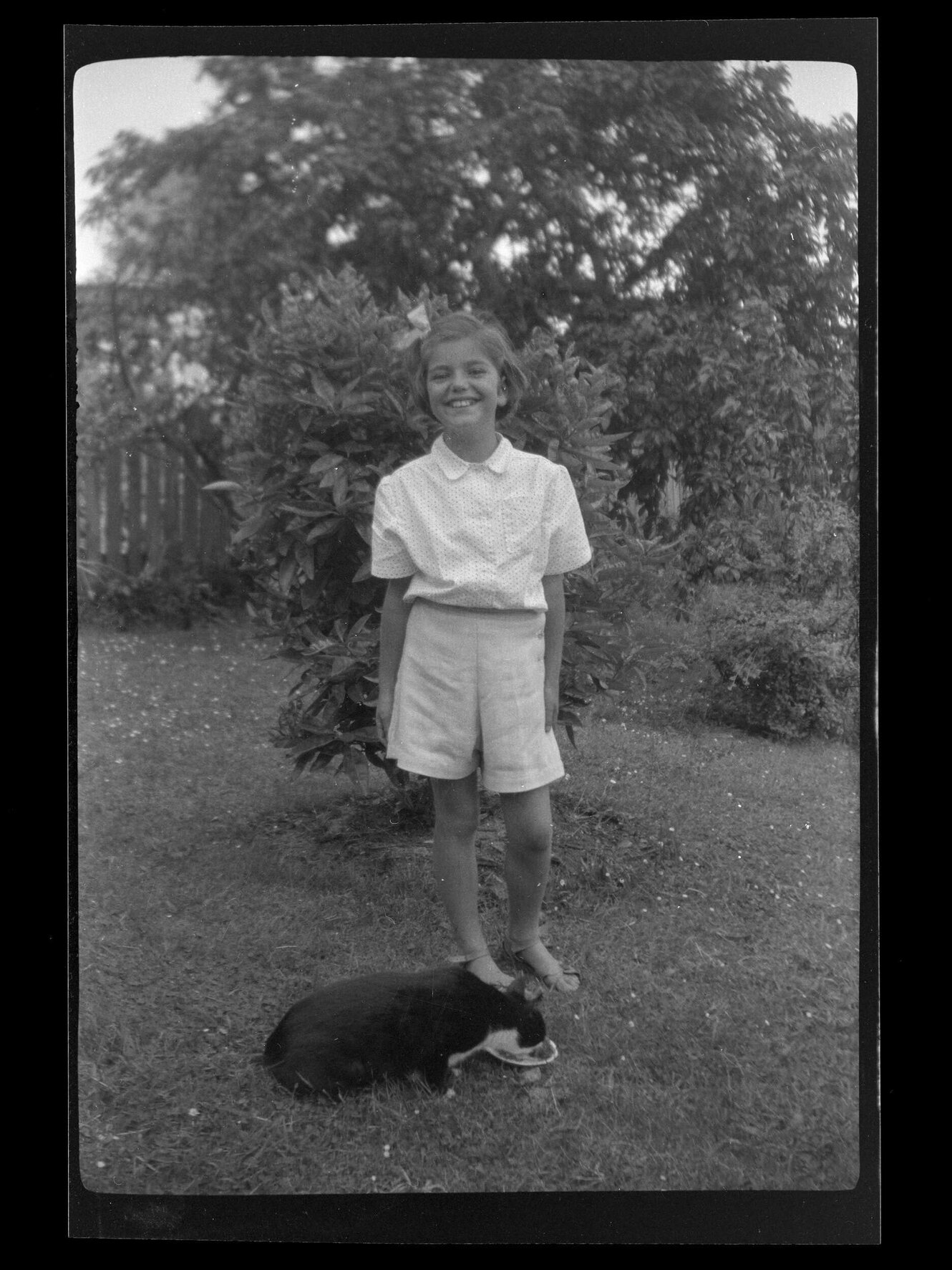 Jannabelle Archdall with a cat in a garden