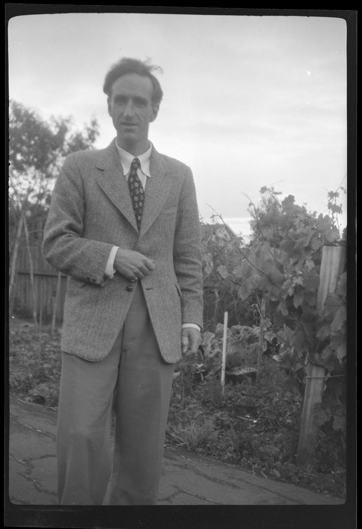 Charles Brasch in a garden