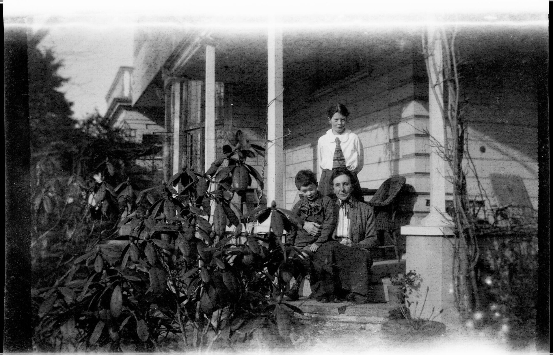 Woman and two children on a verandah