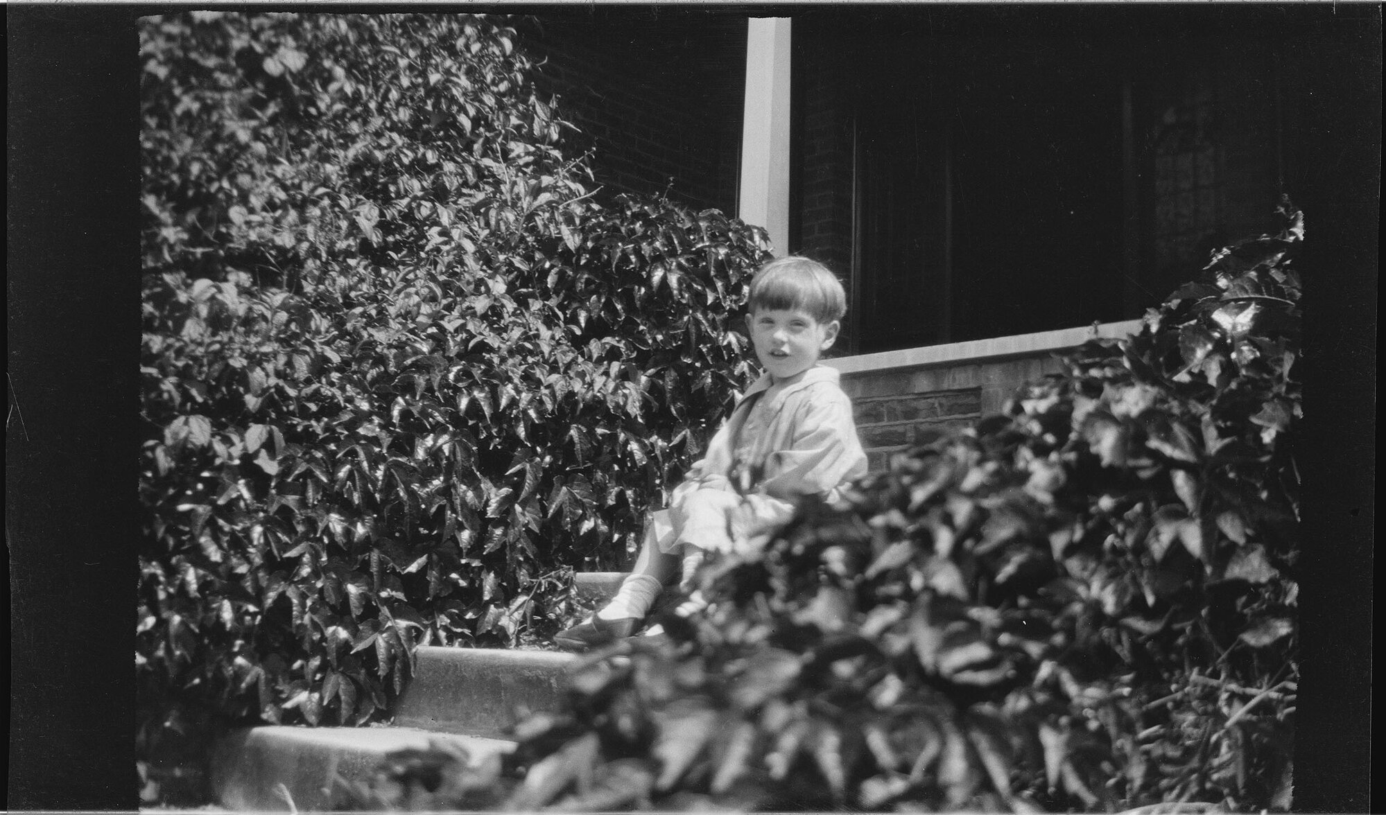 Boy sitting on steps at Manono
