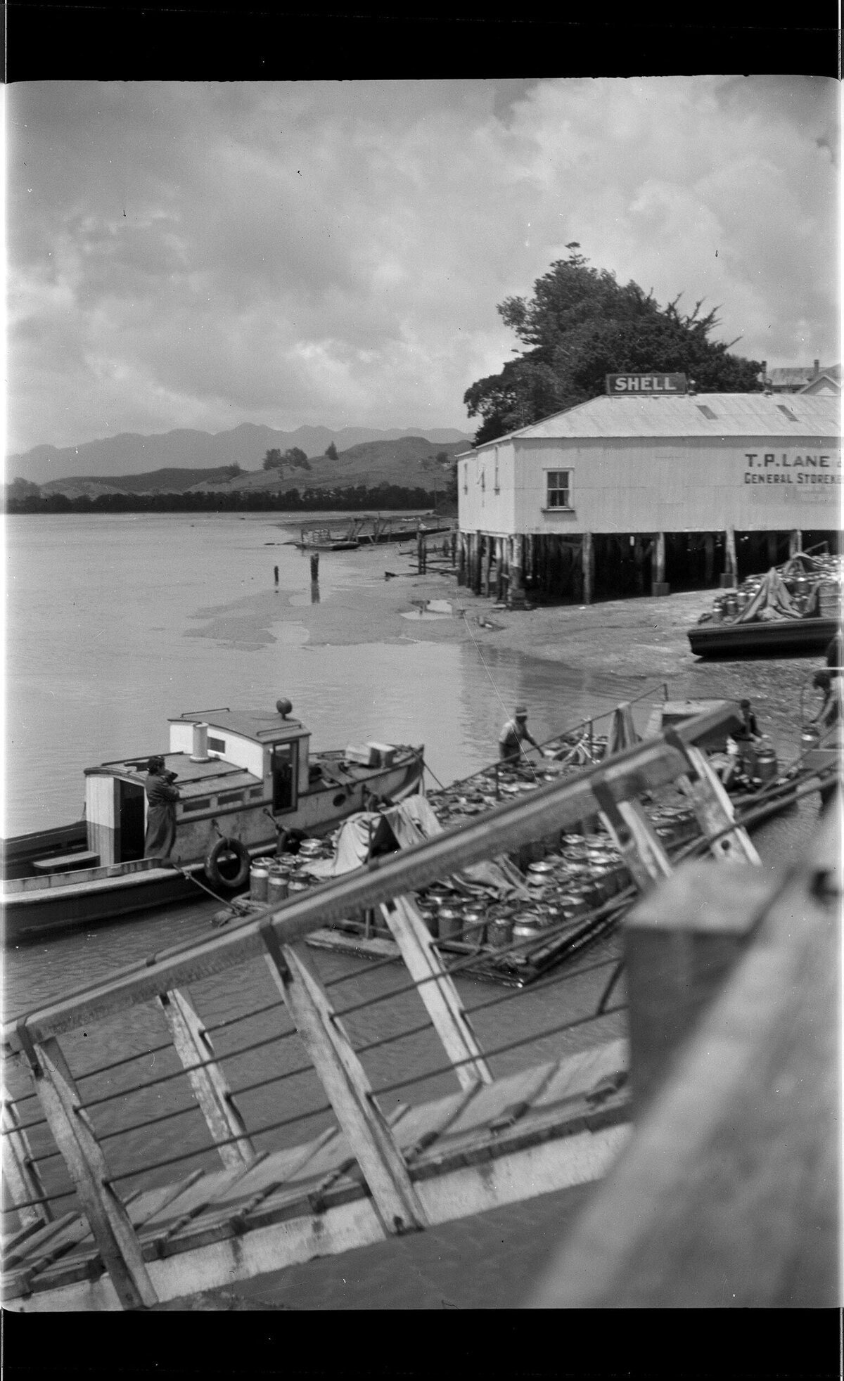 Foreshore at Rawene, including boat and store building