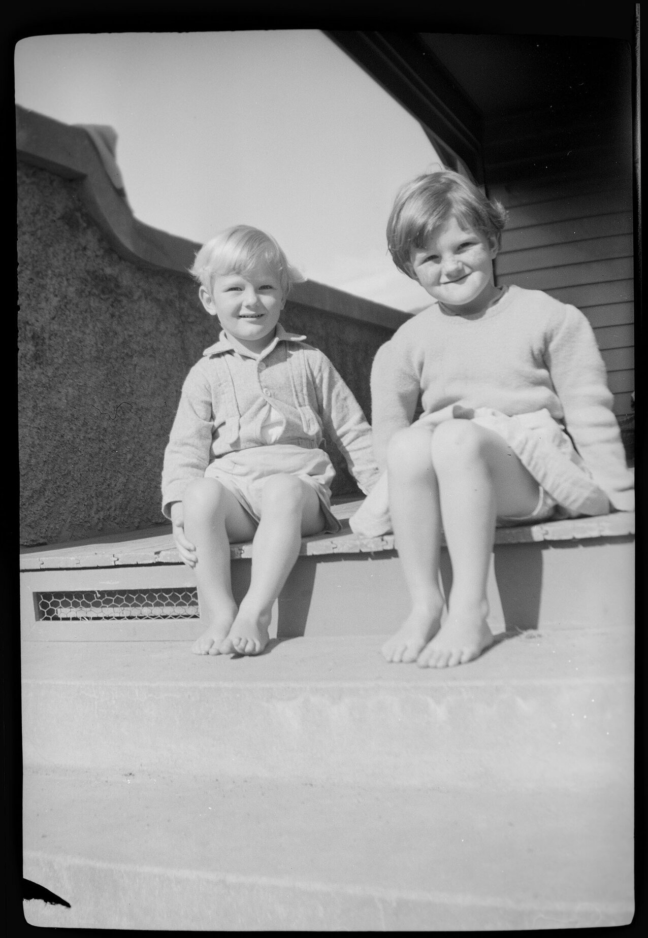 Two of the Thompson children on a step