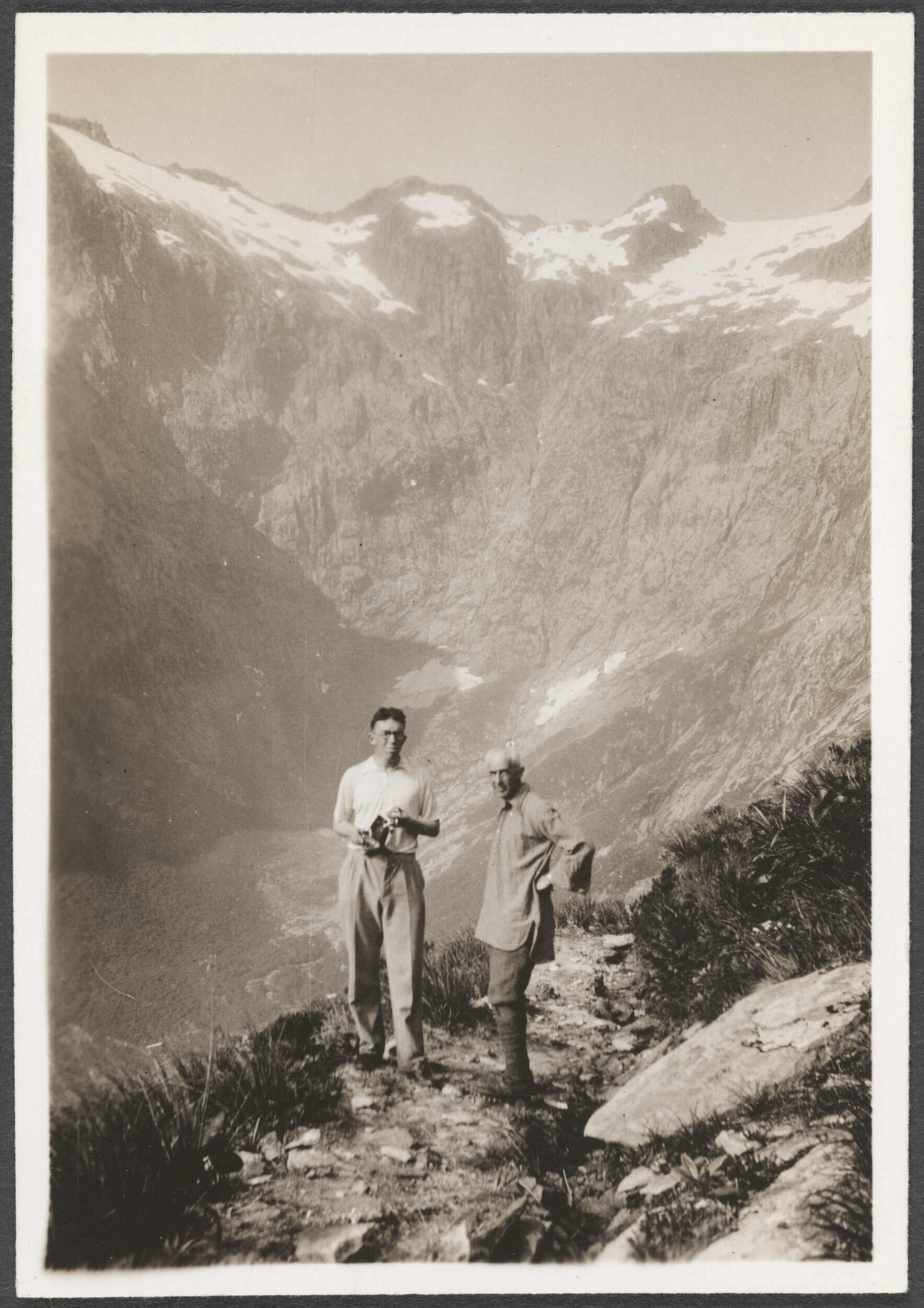 Two men on a hiking track in the mountains