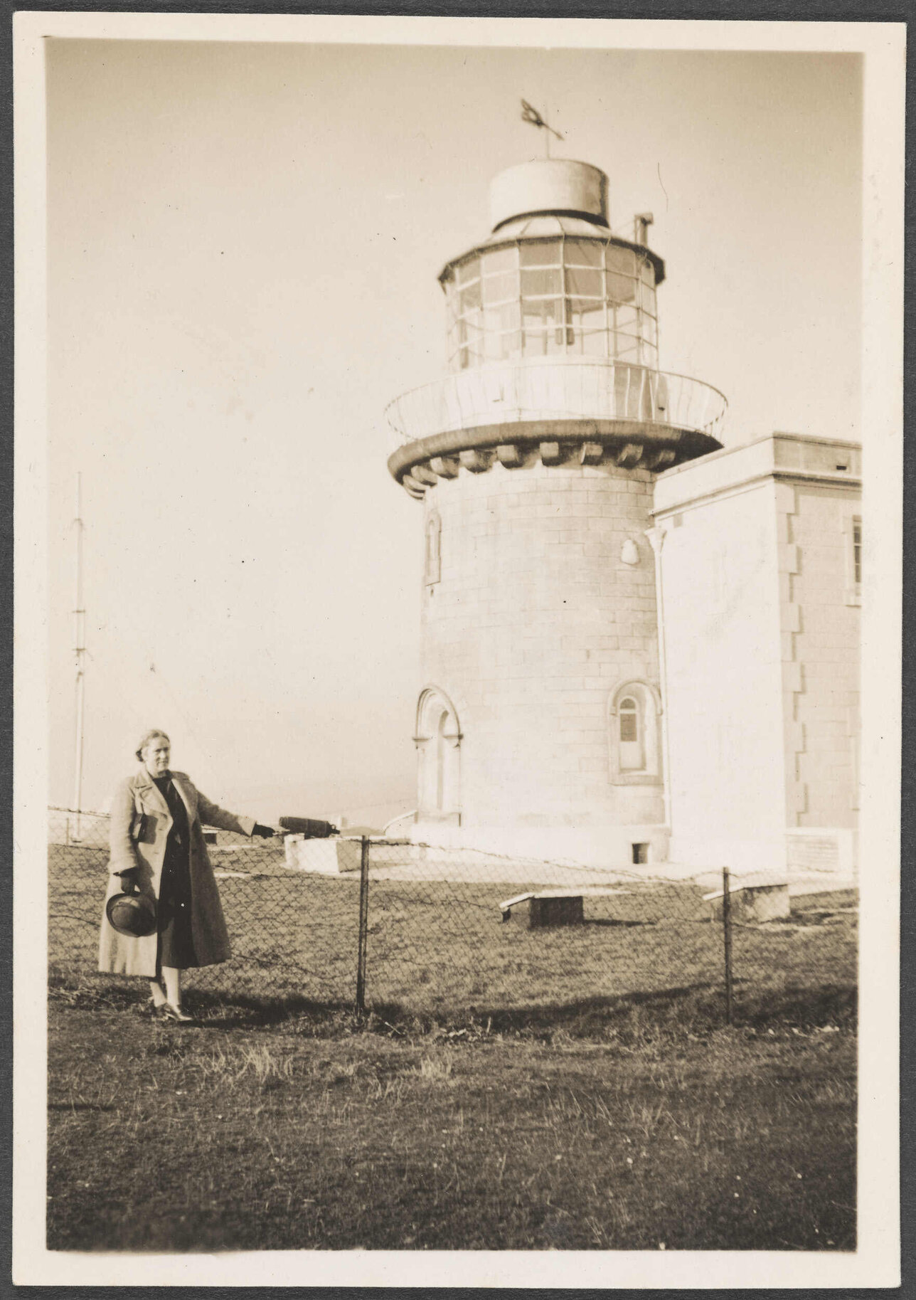 Woman standing in front of a lighthouse