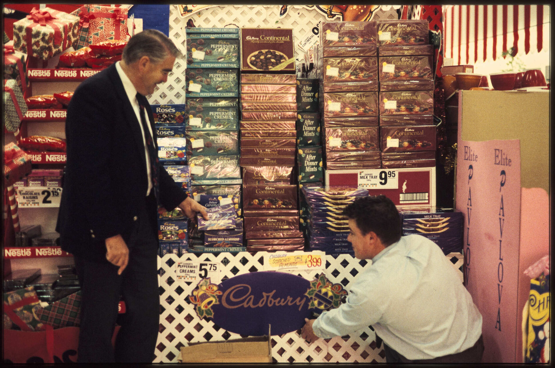 Two men with Cadbury display stand