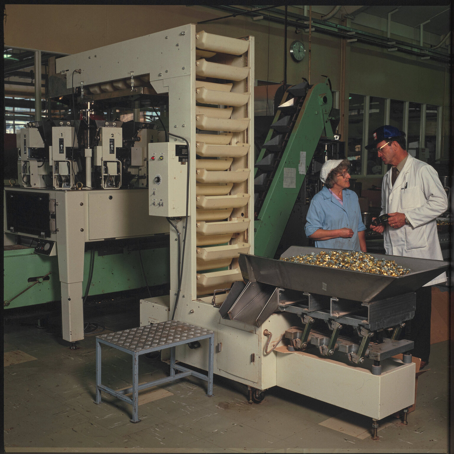 Cadbury production staff with machinery and wrapped chocolates
