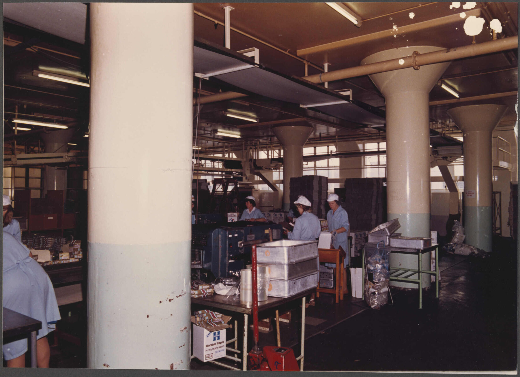 Finger Biscuits. General view of packing end with overhead cooling conveyors in the background.