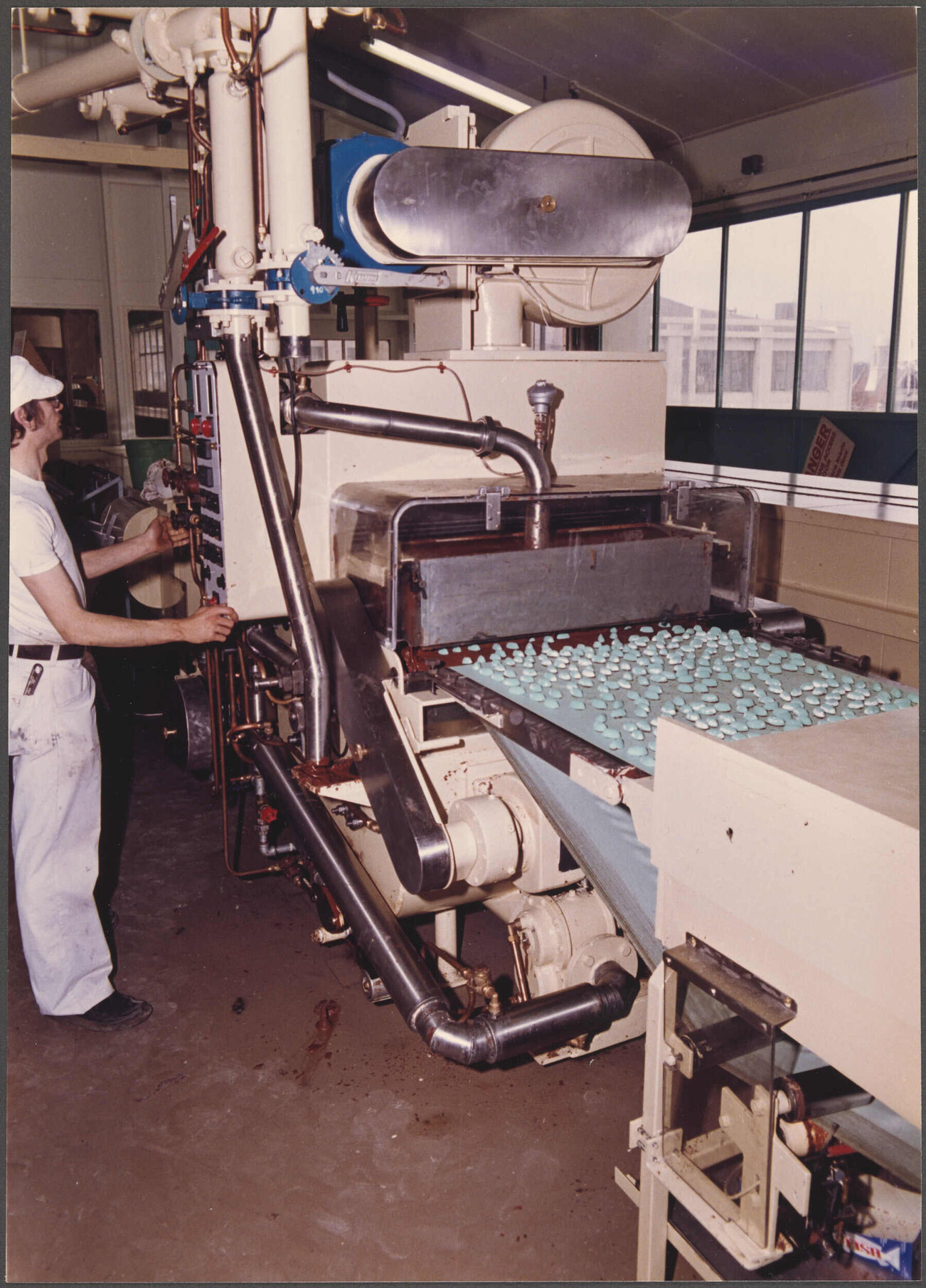 Assortment units entering enrober from bottom cooling tunnel