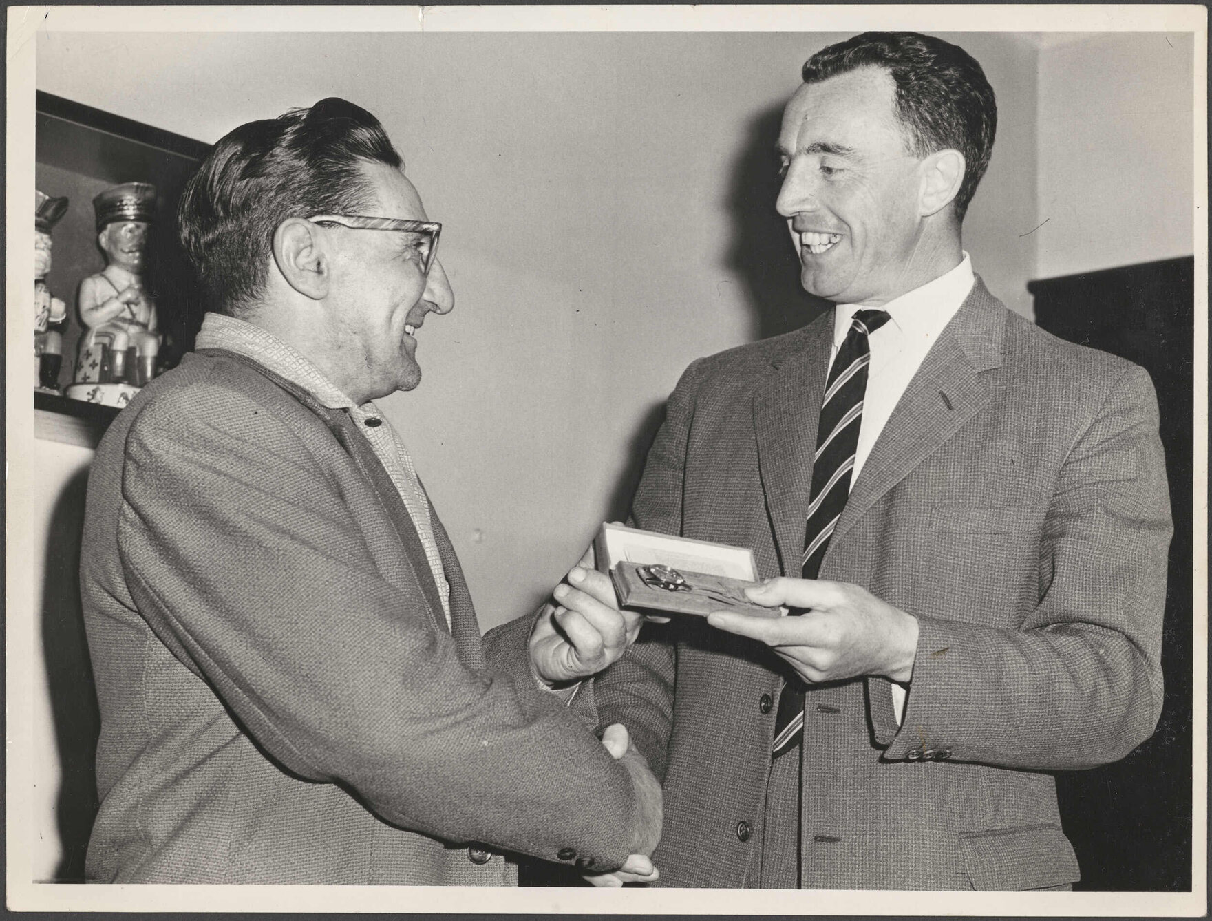 Bob Dennison receiving a gold watch from Ted Barringer