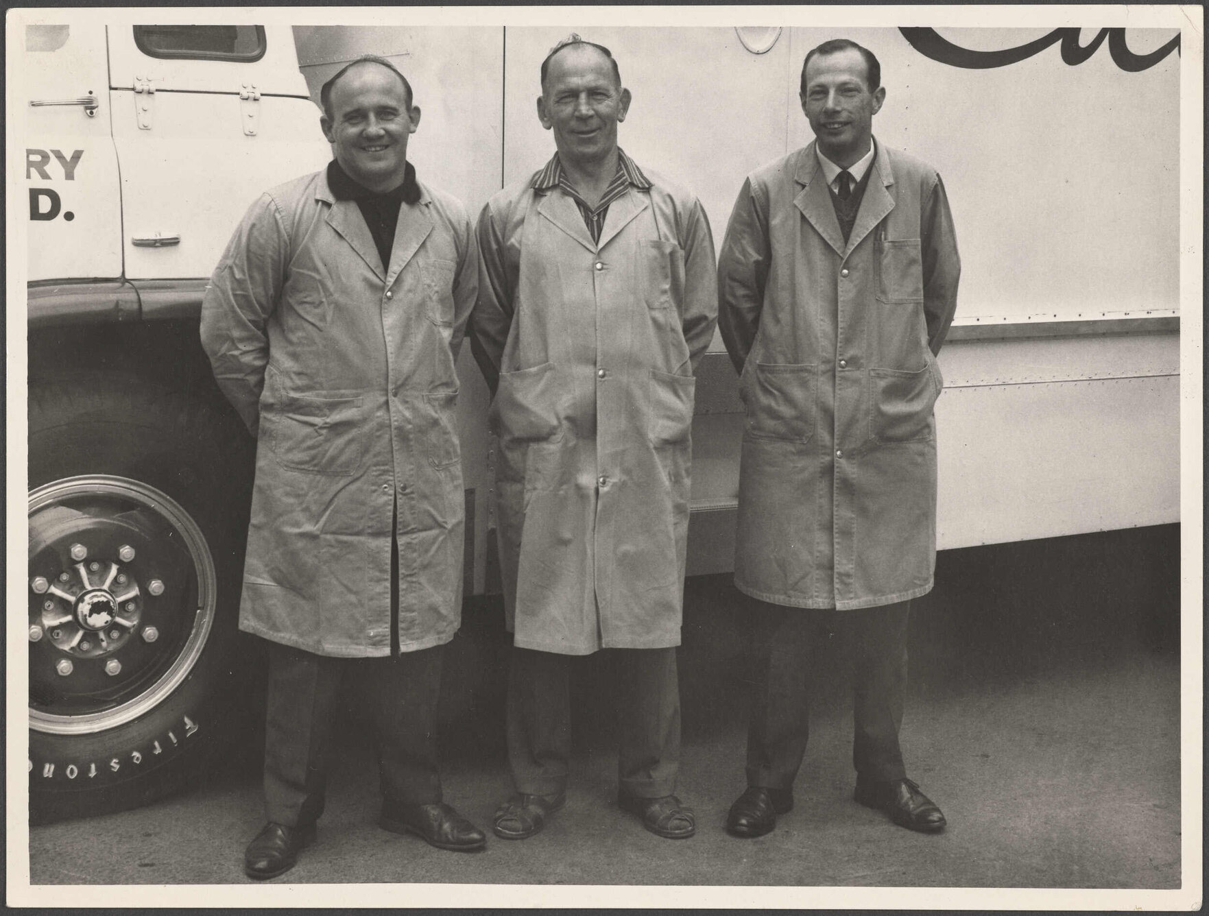 Three men standing in front of a Cadbury Fry Hudson truck