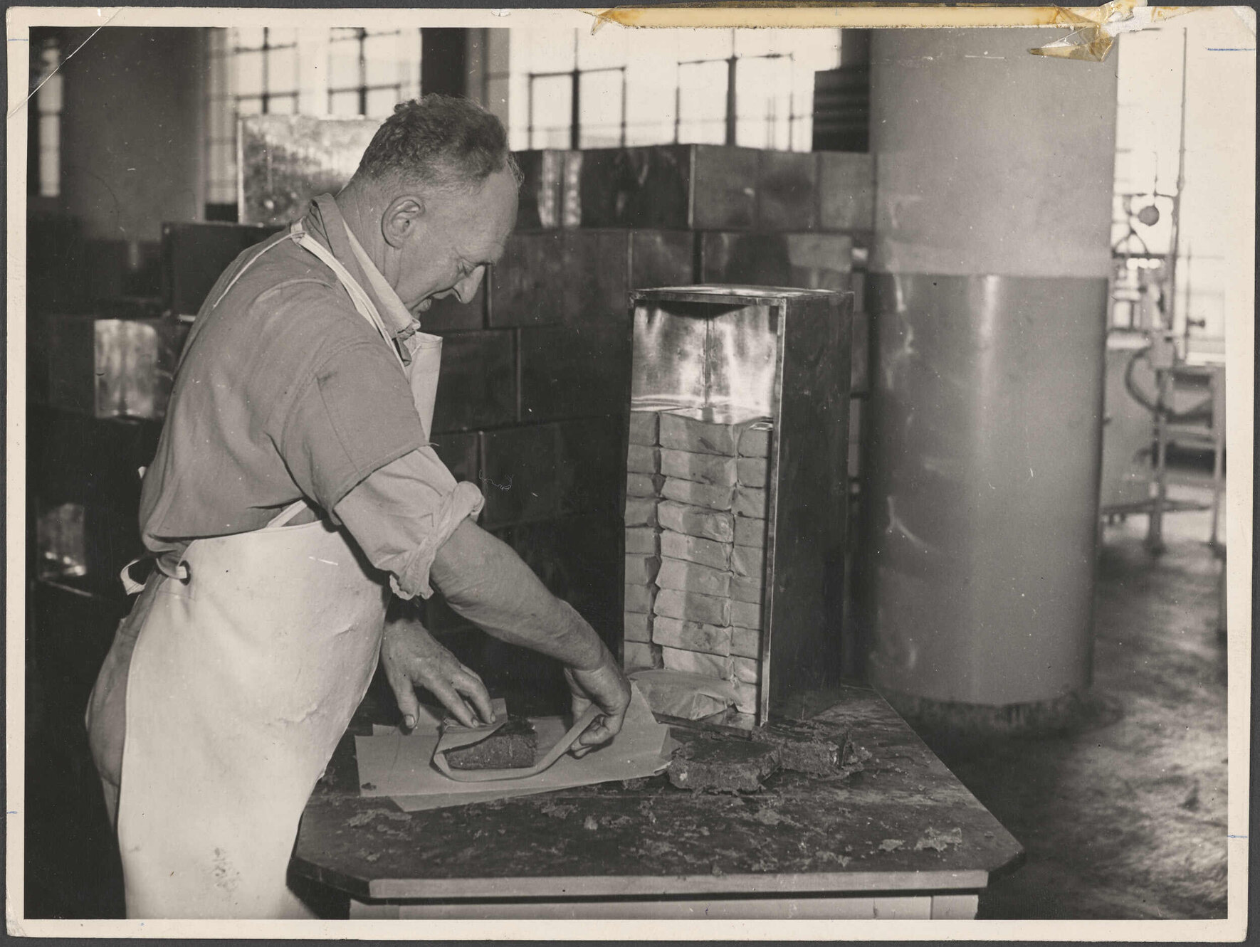 Man wrapping product at Cadbury Fry Hudson factory