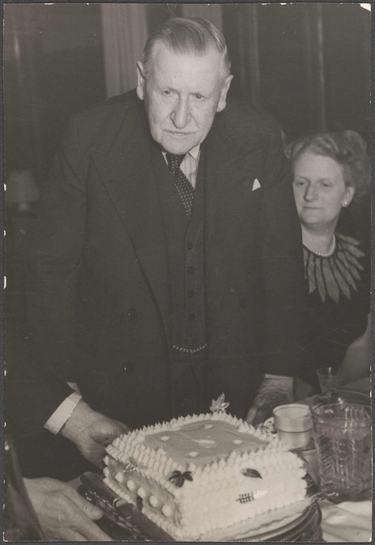 Richard Hudson about to cut the twenty-first birthday cake of the C.F.H. Miniature Rifle Club