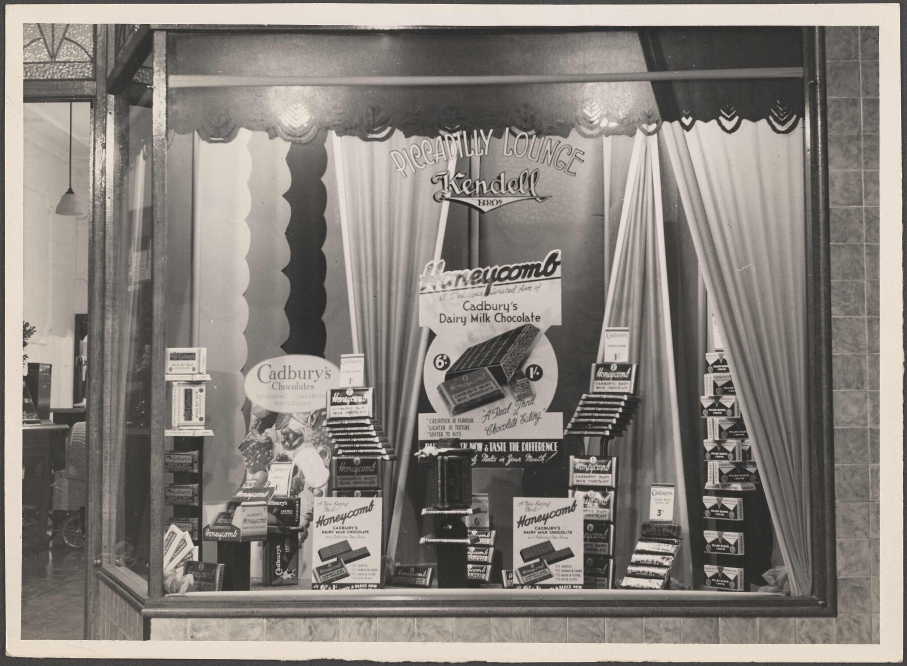 Window display for Honeycomb and other Cadbury's chocolate at Kendall Bros Piccadilly Lounge