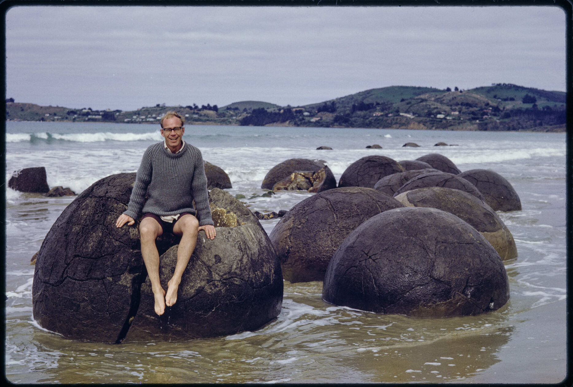 Murray Hanan sitting on a boulder at Moeraki