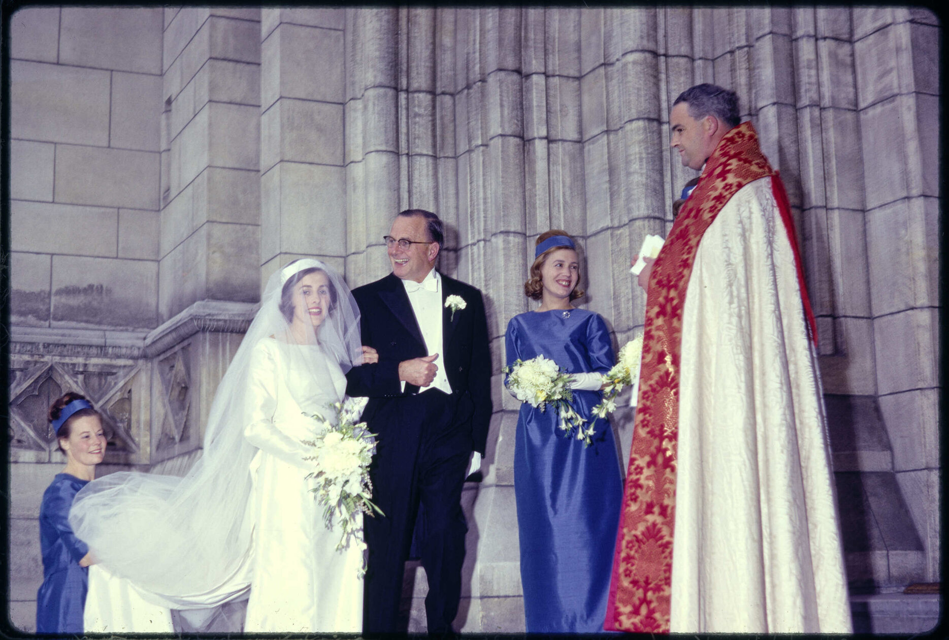 Elizabeth Walsh with her father Sir John Walsh, bridal party, and minister, on her wedding day