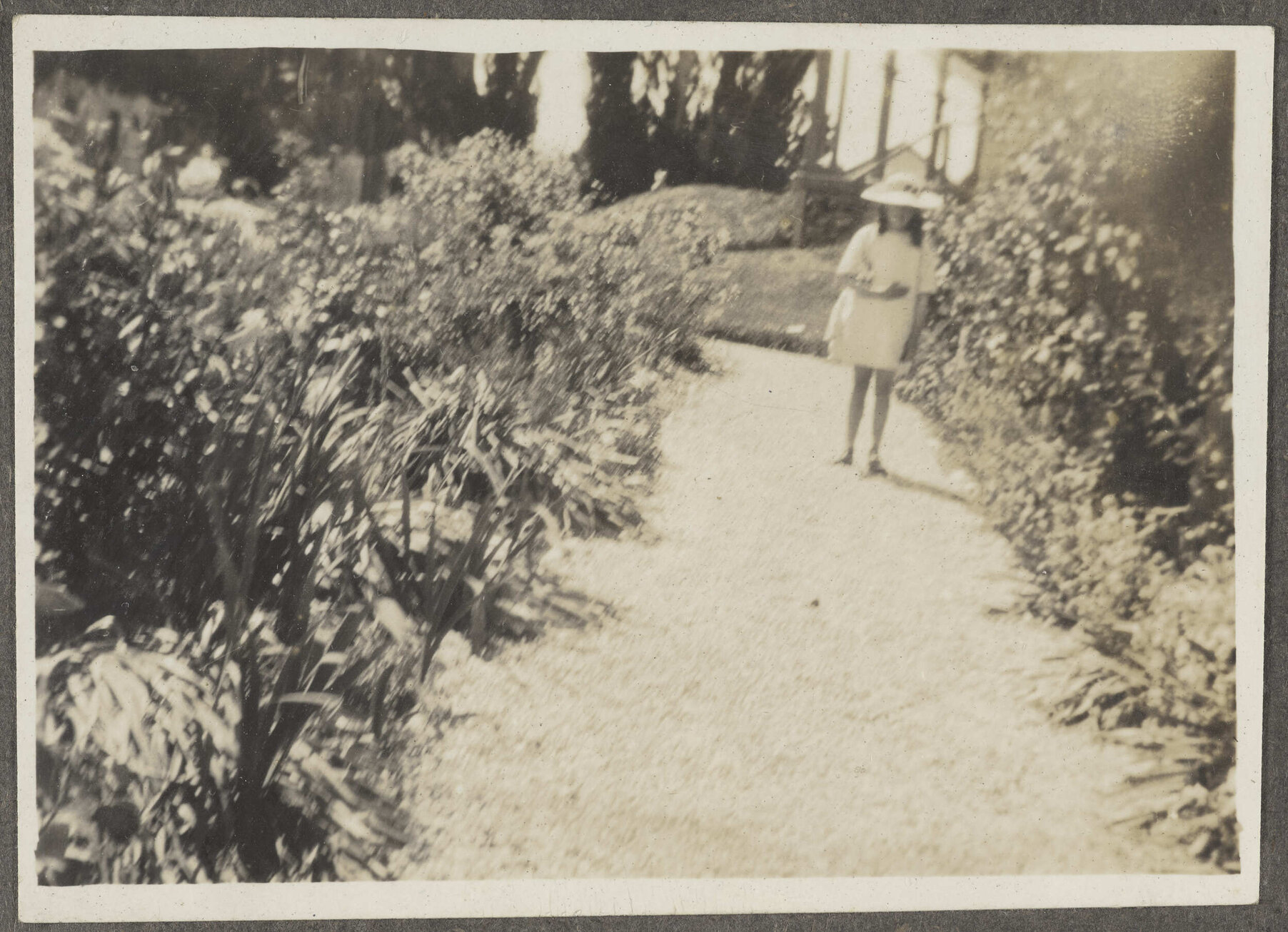 Unidentified girl walking down stone path