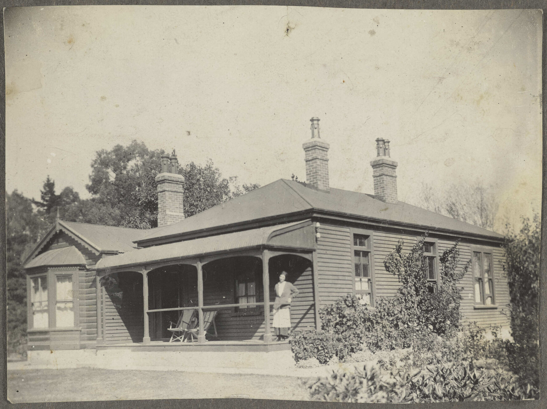 'Amberly, the old house' with unidentified woman standing on the porch