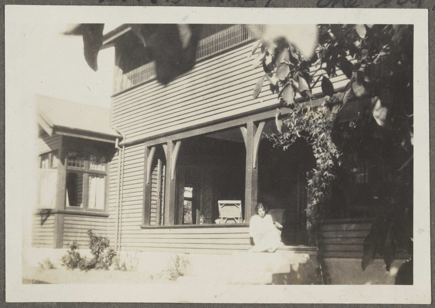 'Amberly, the old house' with unidentified woman standing on the porch