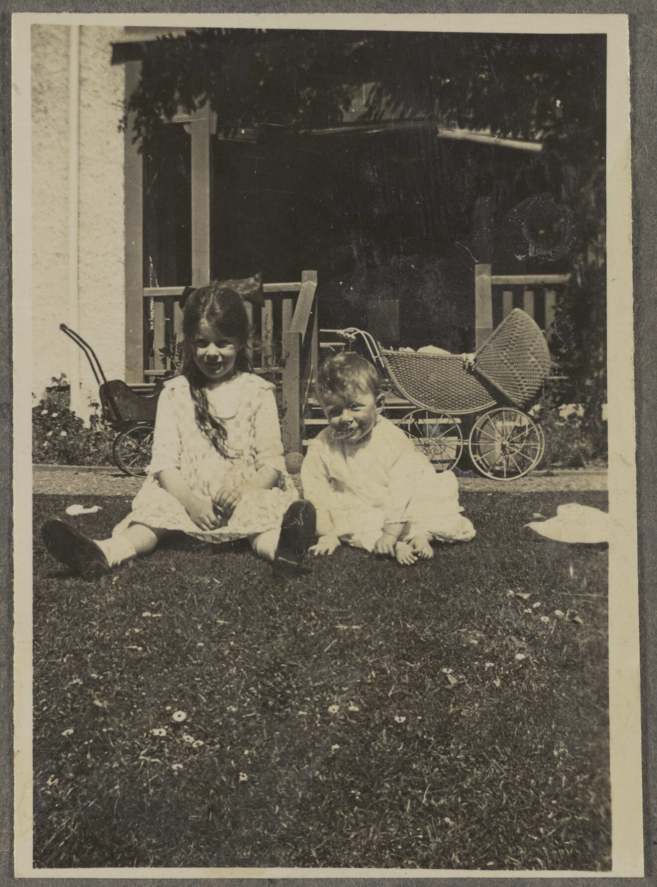 'Amberly, the old house' with two unidentified children on lawn with stroller in the background