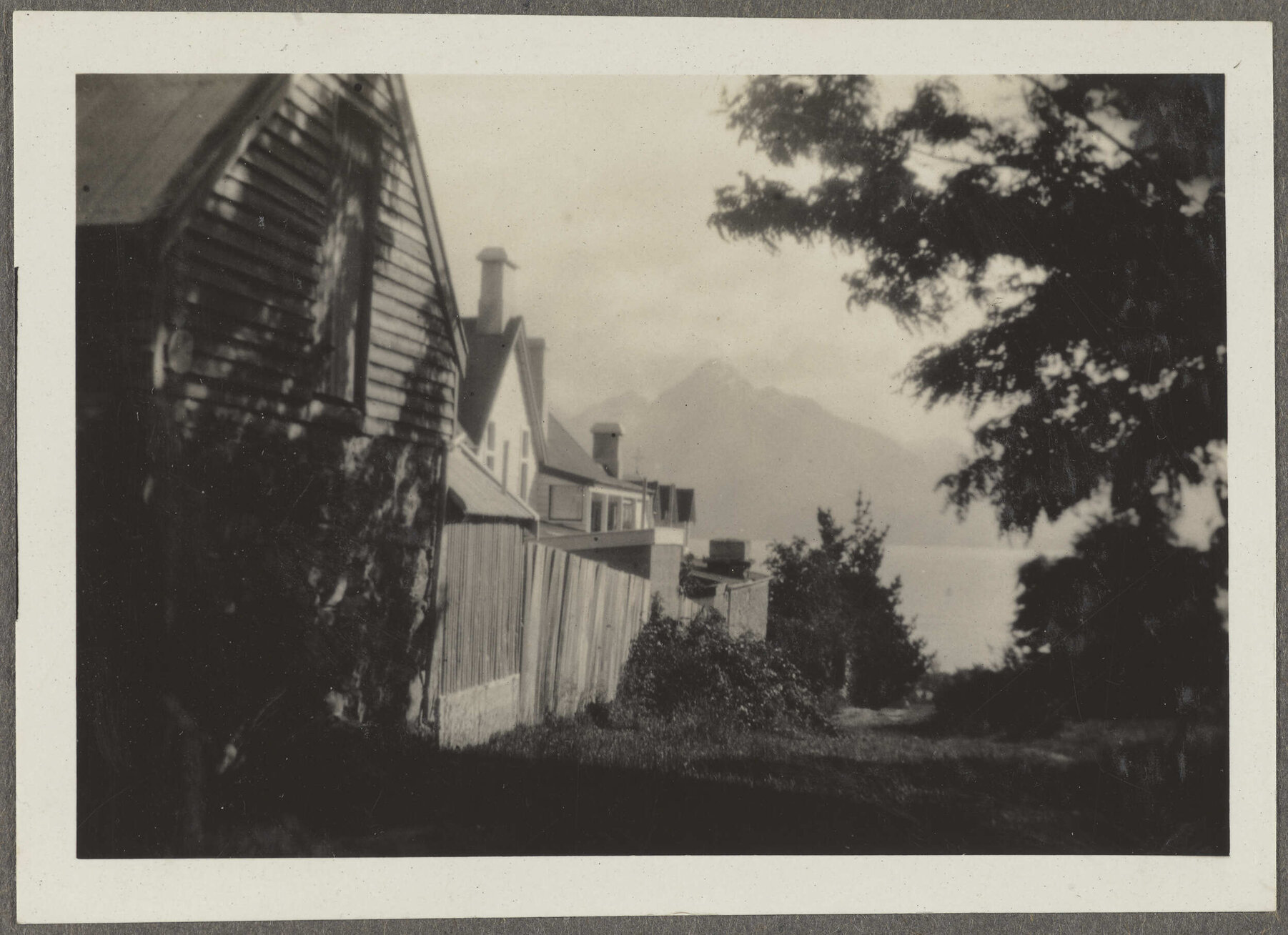 Fence line and house with mountains in the background