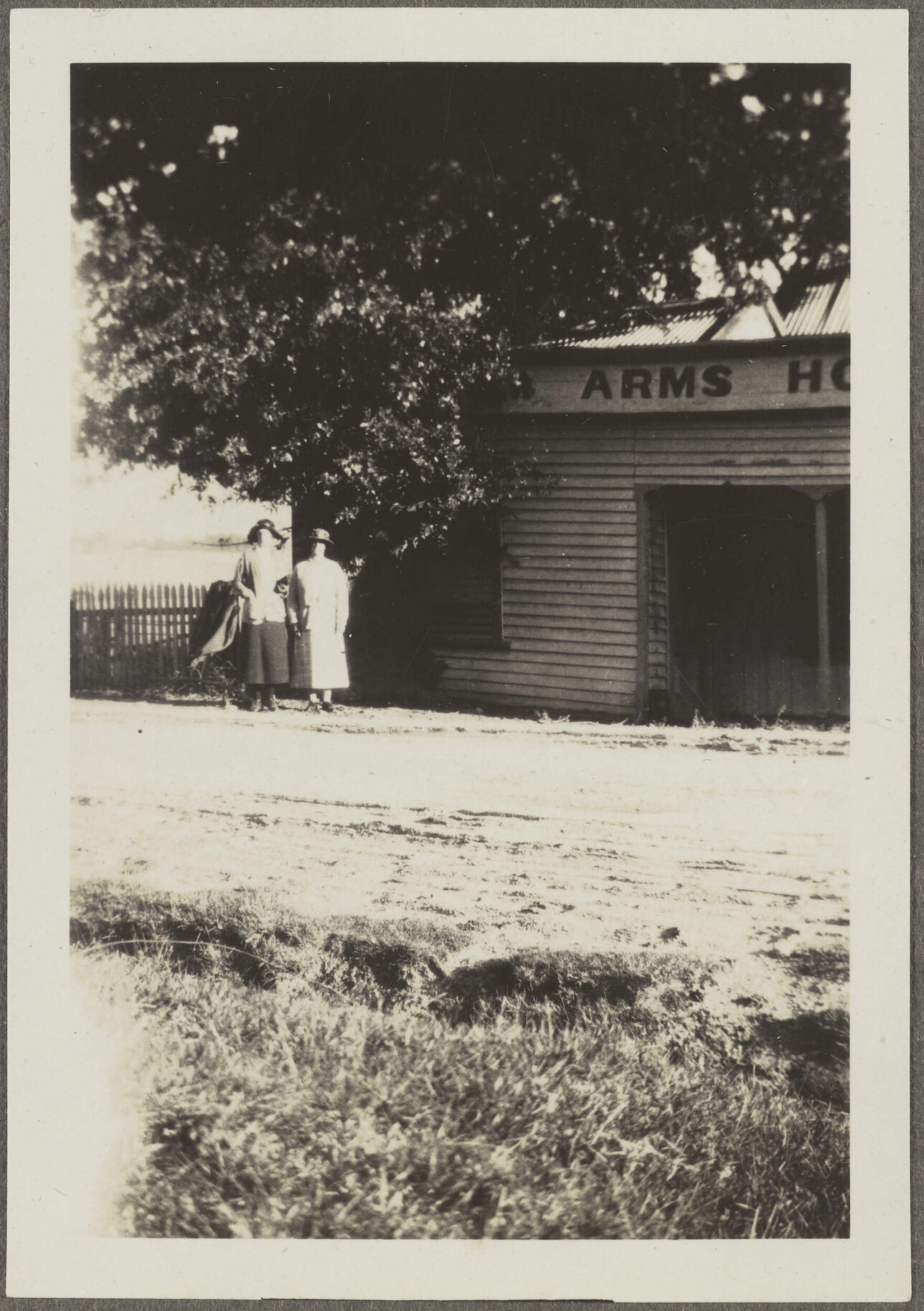 Two unidentified women standing outside Arms [? Hotel]