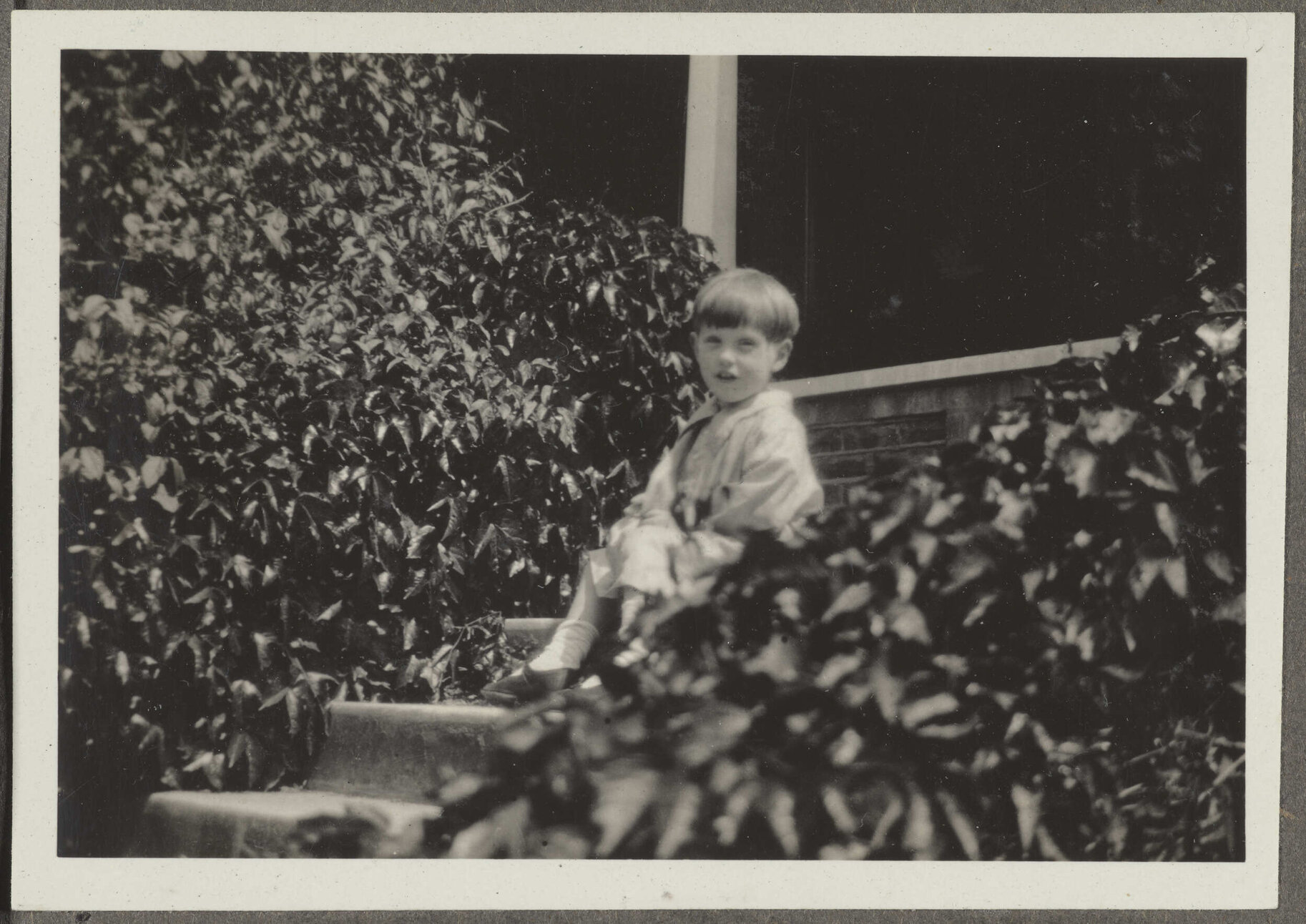 Unidentified boy sitting on steps