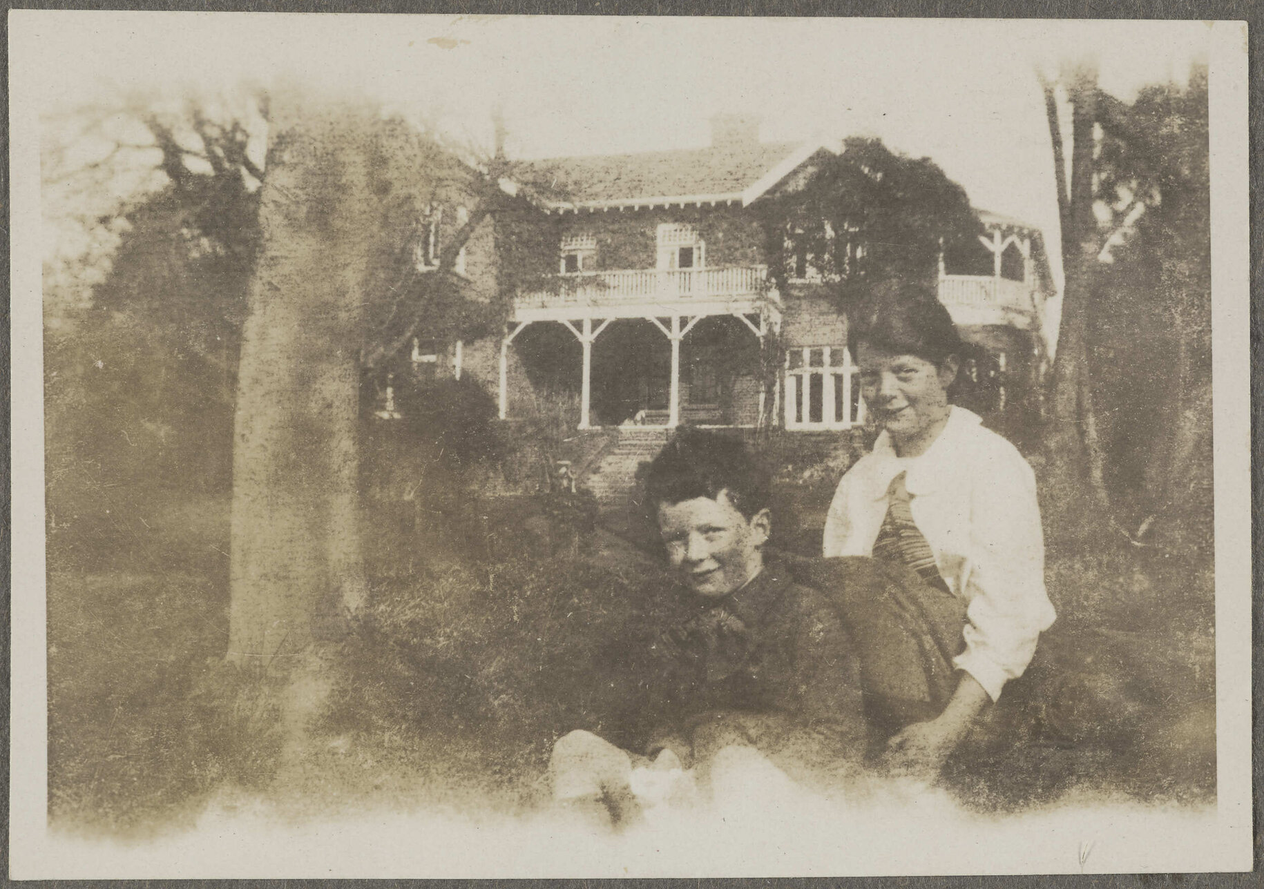 Two unidentified children with house in background