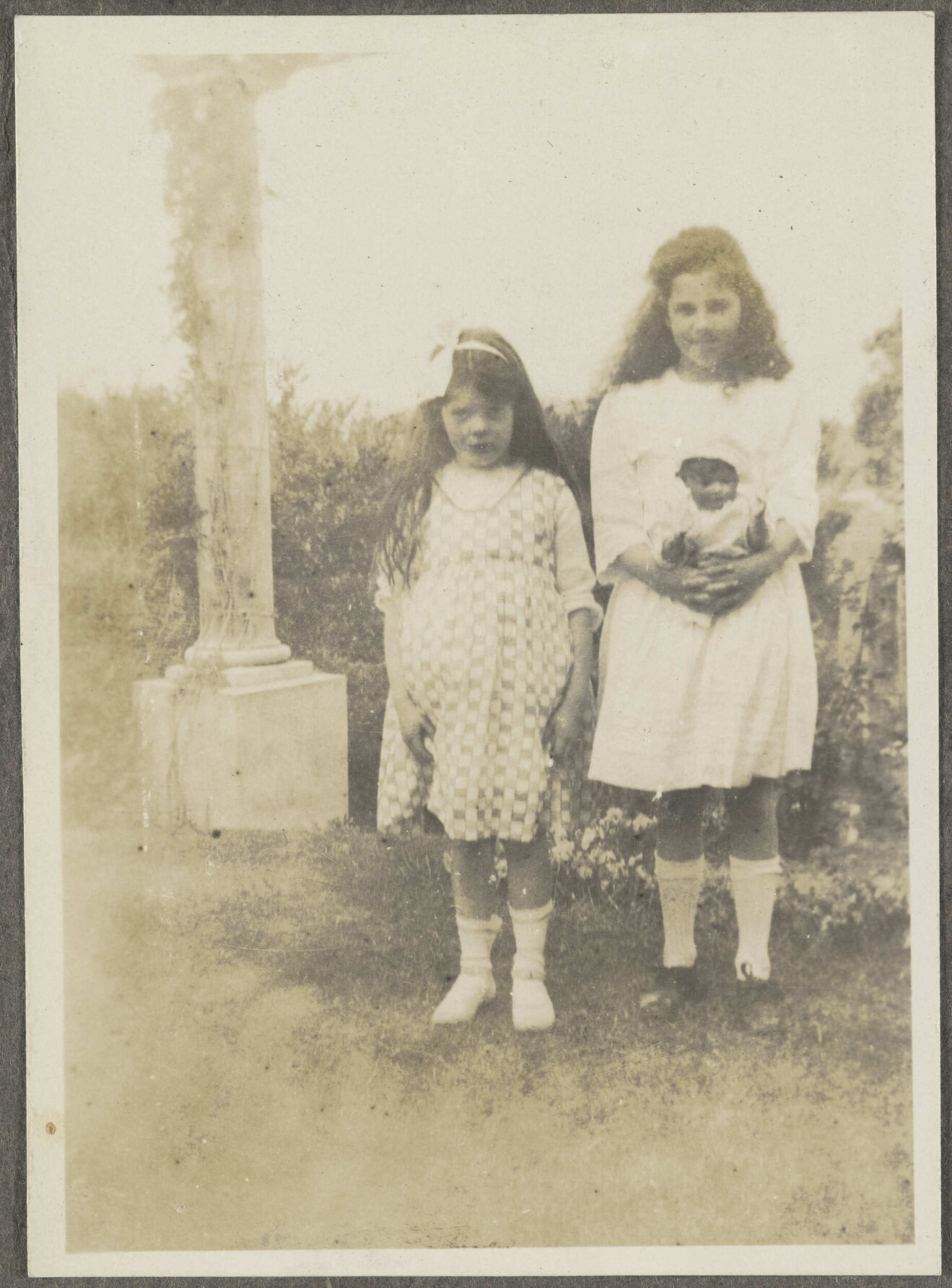 Unidentified girl and Lesley Brasch holding a doll