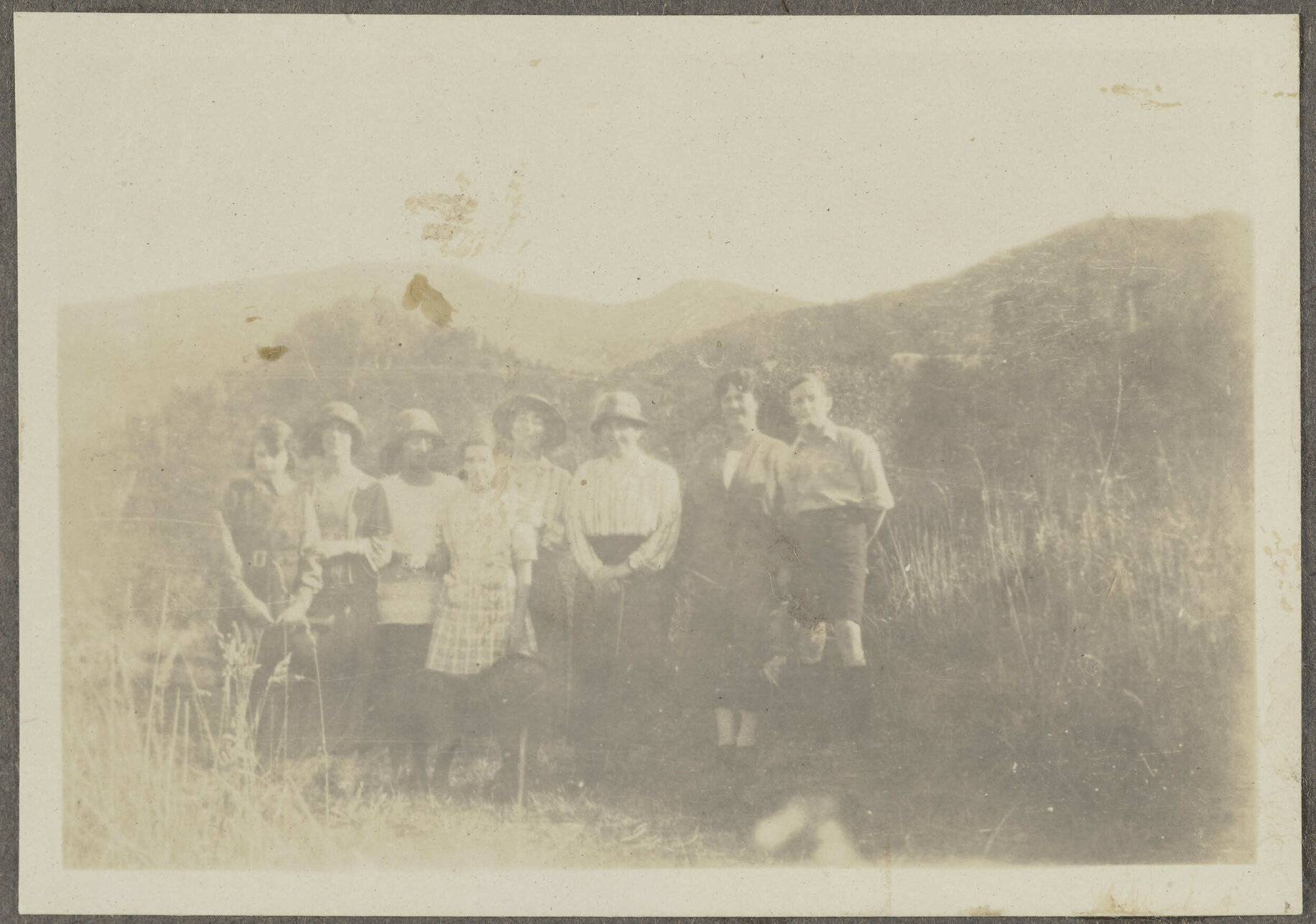 Eight unidentified people among grass hills