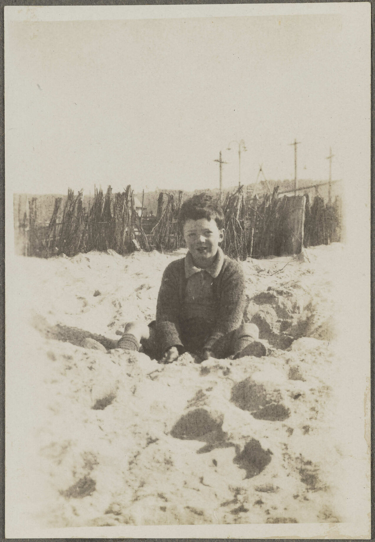 Unidentified child sitting in sand